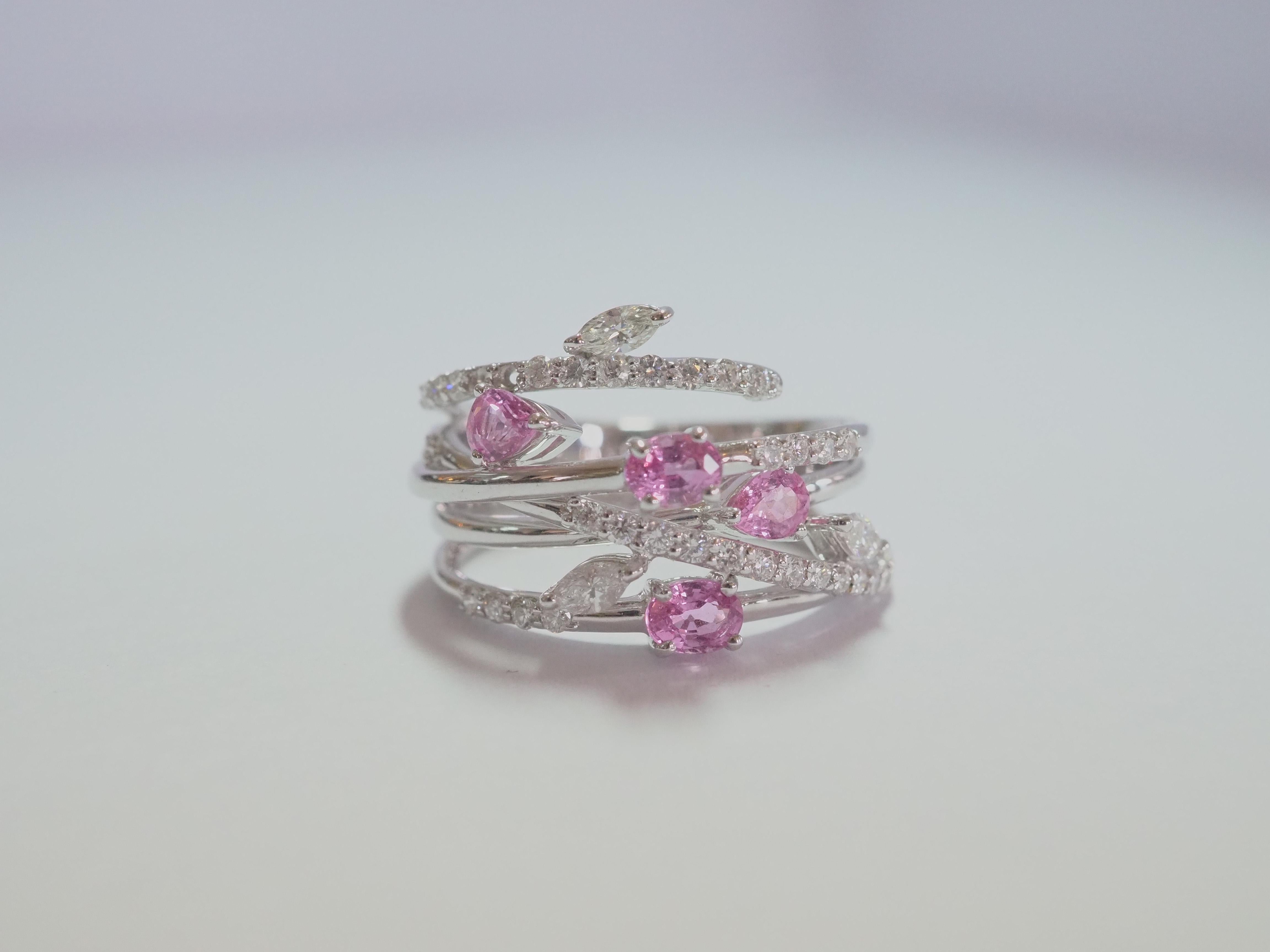 This fine designer piece is very elegant. The bright bubblegum pink sapphires of 2 pear cuts and 2 oval cuts are set neatly on the viny band. This piece is clearly Inspired by floral themes using marquise cut diamonds and arranging them to be flower