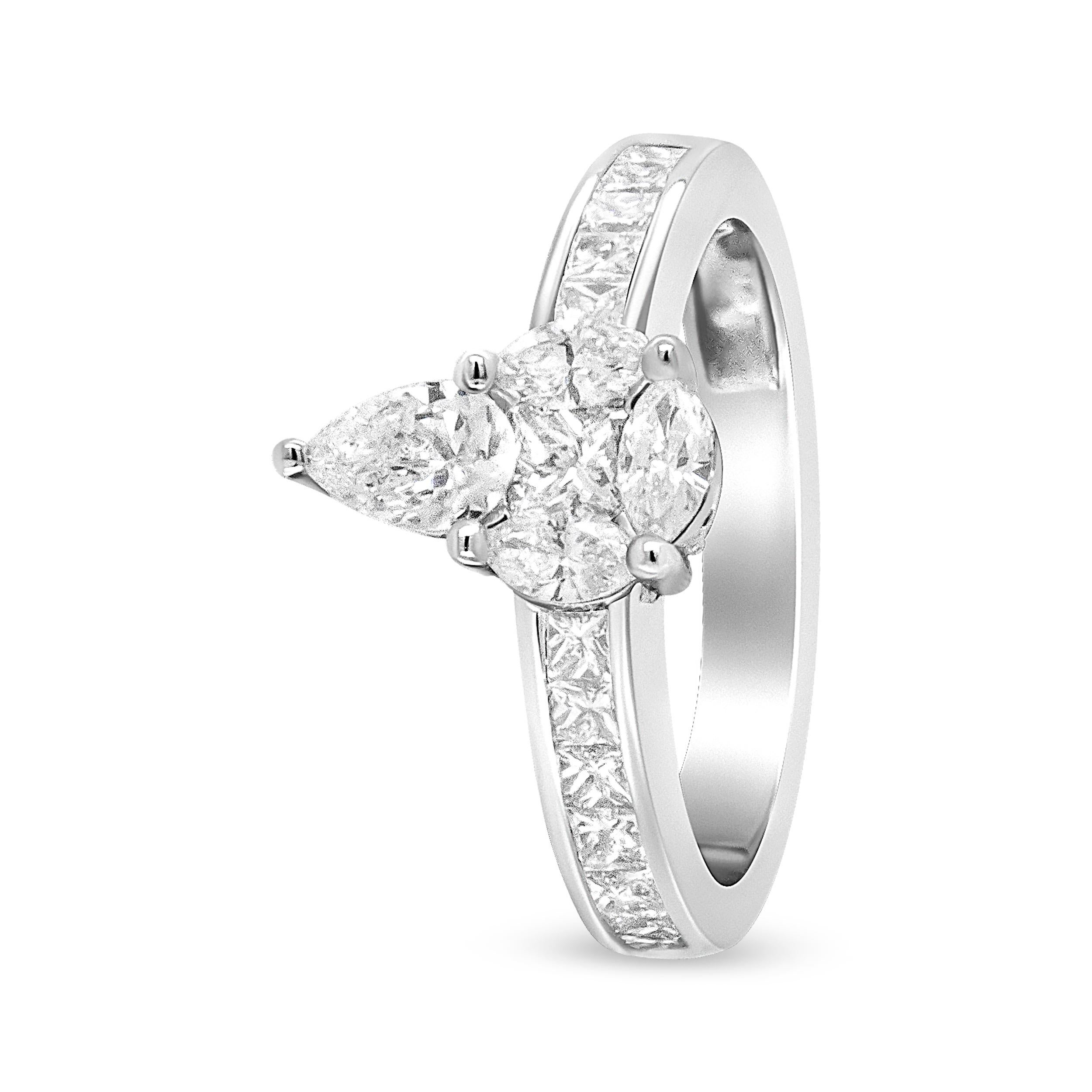 A whimsical take on a classic design, the central motif of this gold band has pear, marquise, and round-cut diamonds crafted together in a modern illusion of a design. A pear cut diamond sits on top of the central round-cut stone, which is flanked