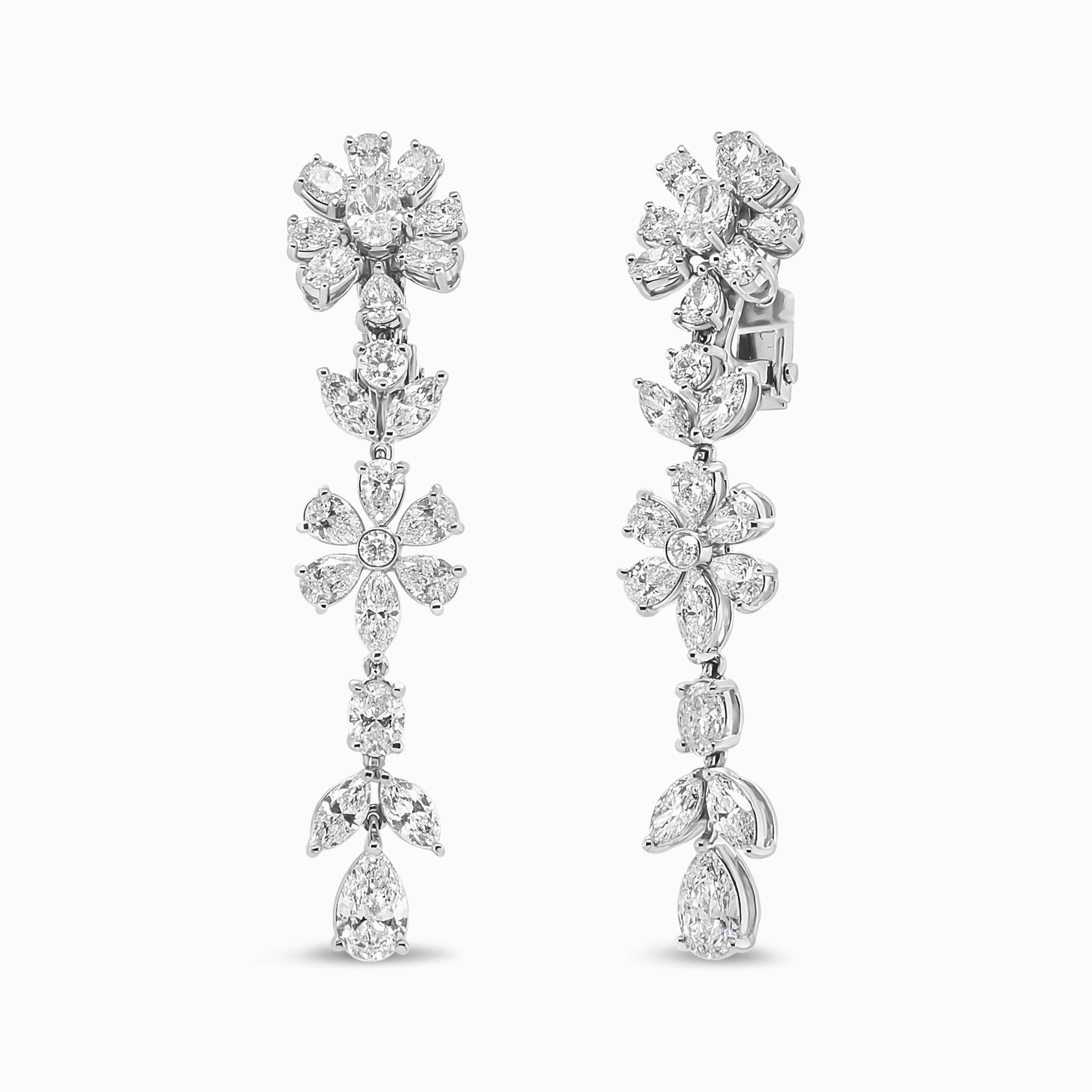 A perfect complement to any look, this richly presented pair of diamond flower earrings is a fresh and stylish approach to accessorizing. This intricate flower motif bestows elegance and sophistication to its wearer, exemplifying excellence in with