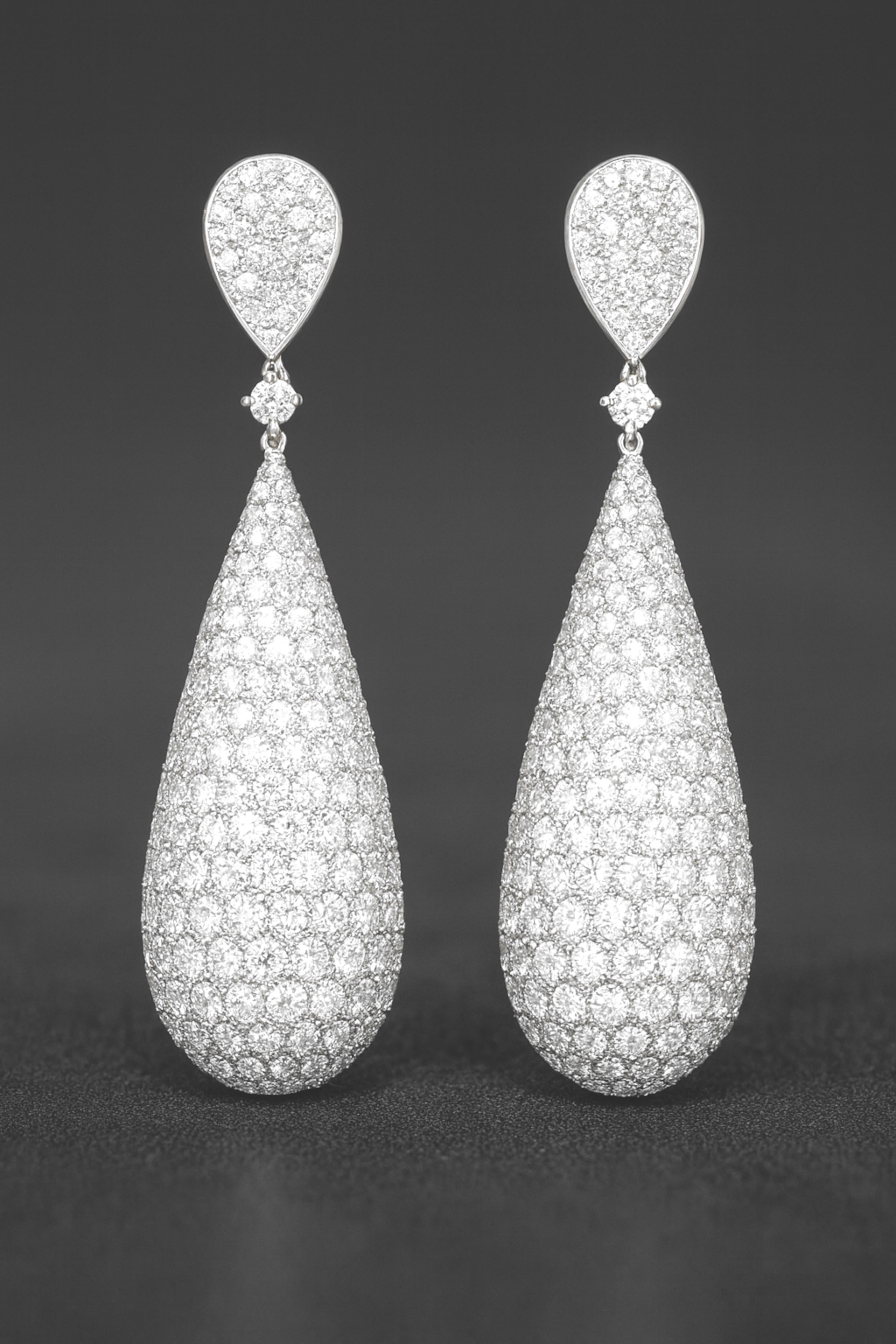 18K White Gold 10 Carat Round Diamond Pave Drop Earrings

A dazzling pair of statement drop earrings crafted in 18K white gold, designed with an elegant pear-shaped silhouette and encrusted with an impressive 568 round brilliant cut diamonds,