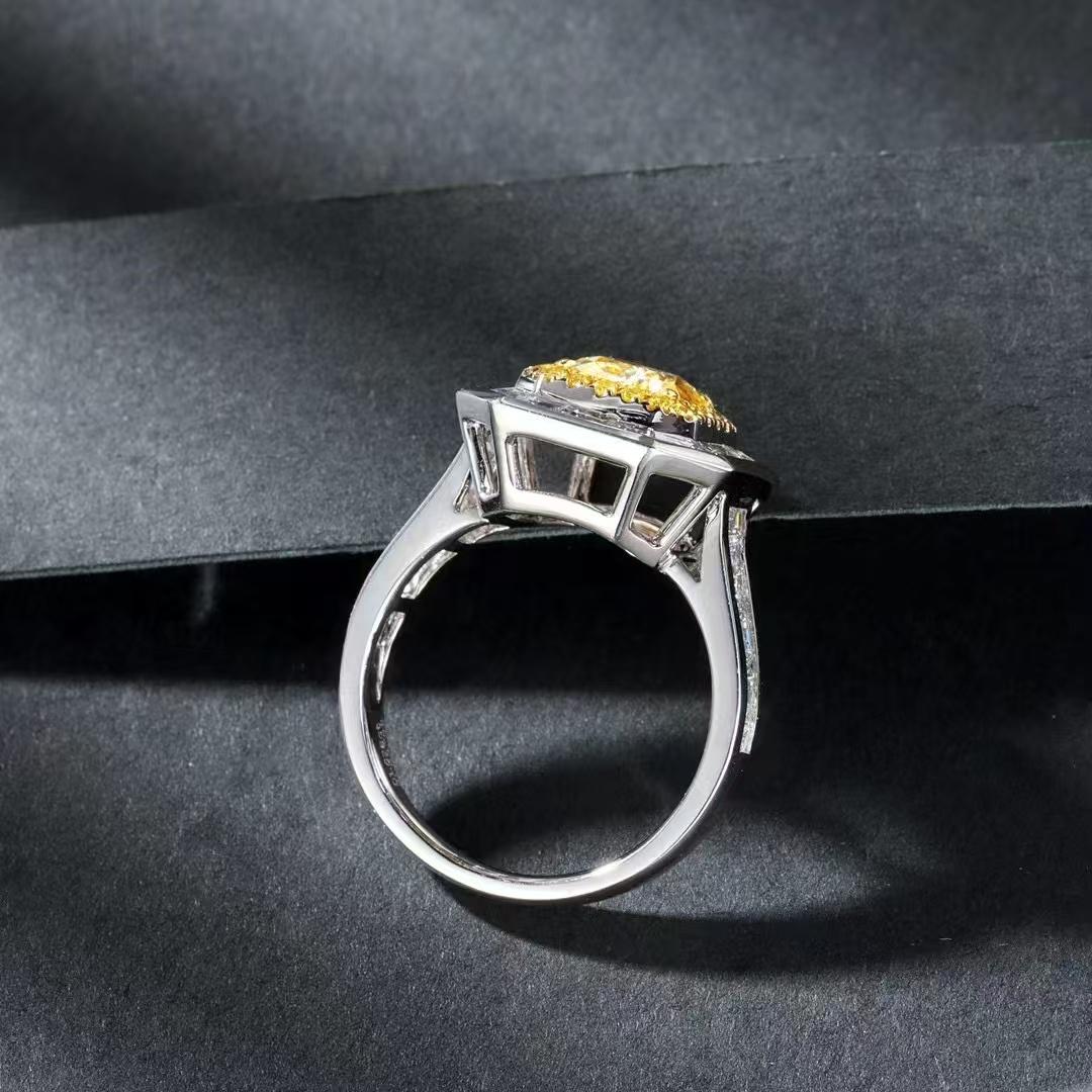 18K White Gold 1.007ct Yellow Diamond Ring

Main Diamond- 1.007 ct
Side Diamonds - 1.661 ct
Total Weight - 5.660g

This cushion-cutted yellow diamond ring is a masterpiece of jewelry design, radiating opulence and allure.

At its heart lies a