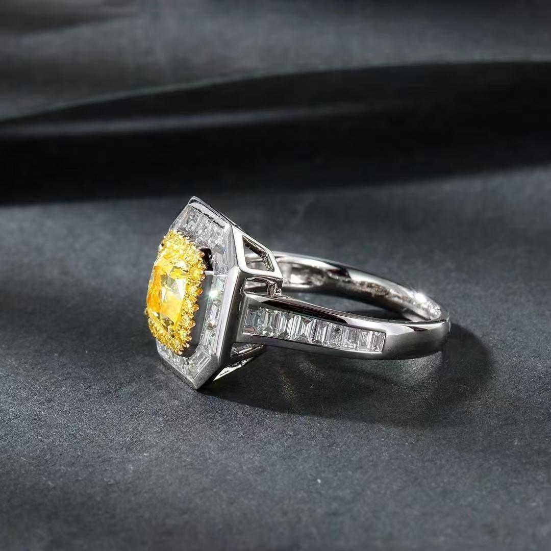 Modern 1.007 Carat Vivid Yellow Diamond Ring with Tapered Baguette Cut Diamond Around For Sale