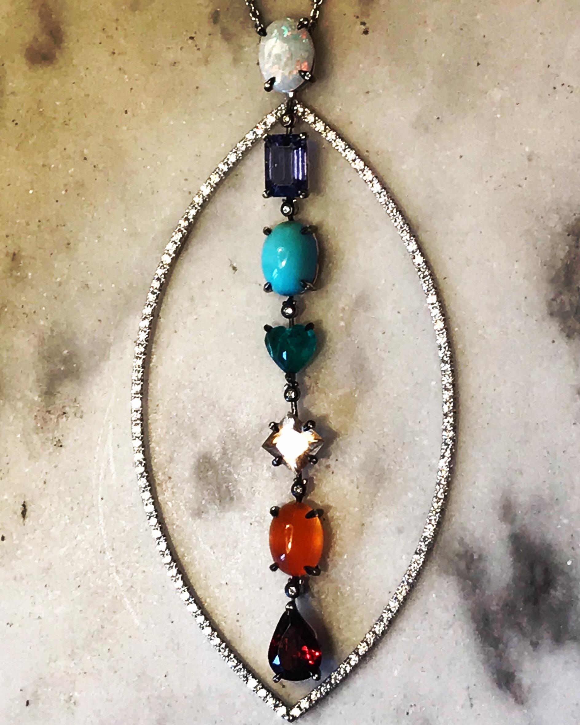 AURA : A white gold, diamonds and colored stones Chakra pendant by Frederique Berman.
This design symbolizes the perfect alignment of the seven main chakras, when open and blooming, so the circulating energy  creates a shining halo around the