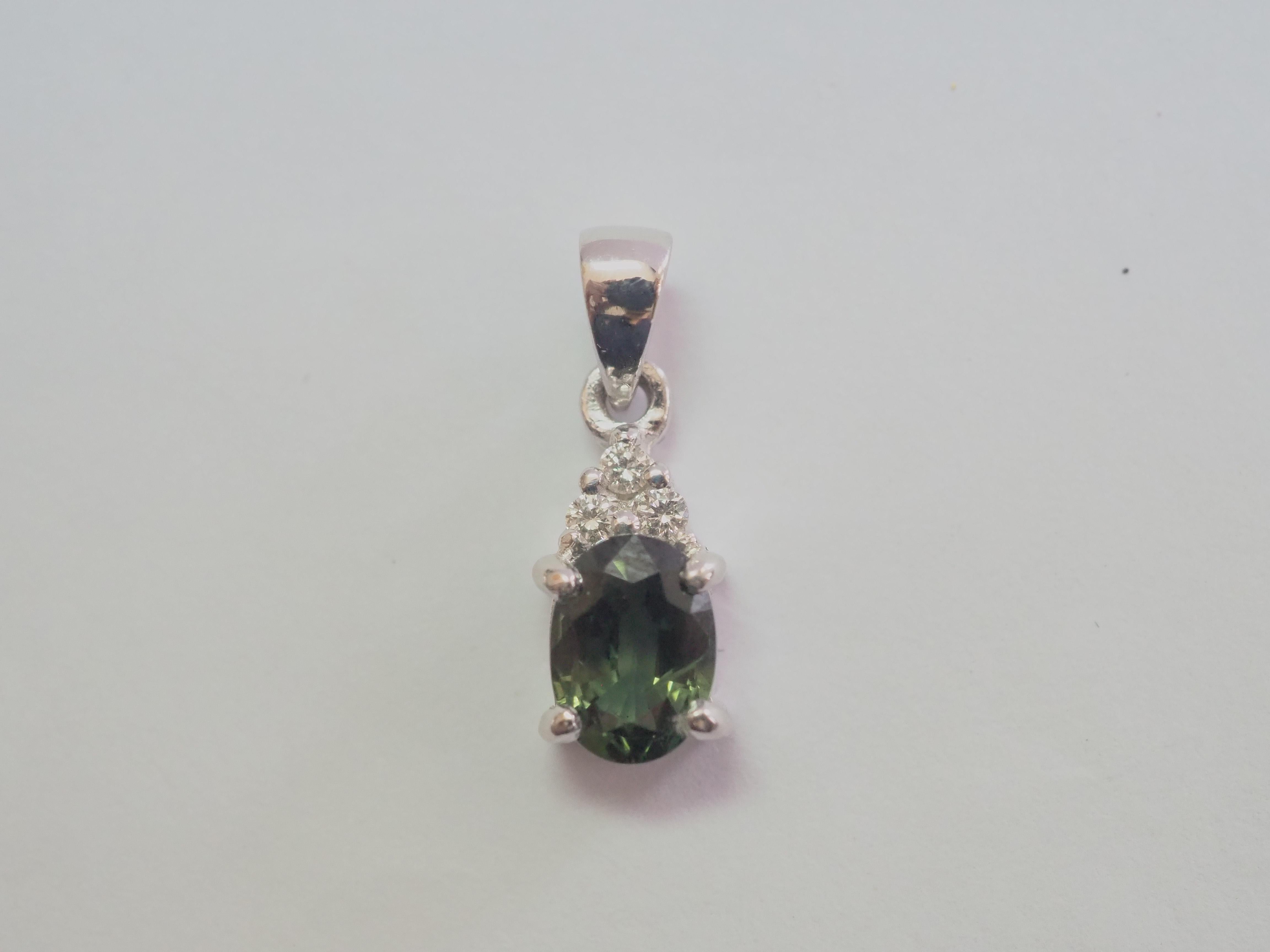 A beautiful and quality pendant enhancer. This beautiful piece is crafted in our workshop using 18K white gold. The piece is adorned with a gorgeous 1.02 carats oval green sapphire and with 0.05 carats of bright and lively brilliant diamonds to add