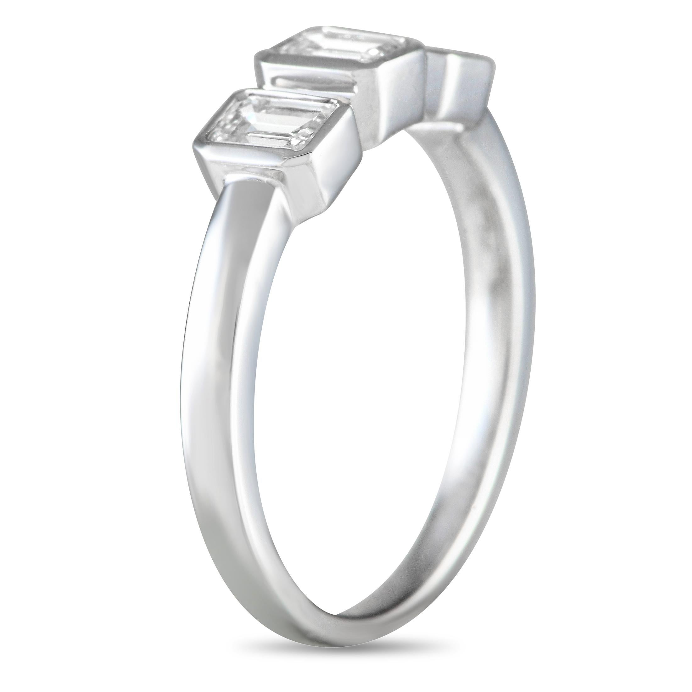 A trio of step-cut Diamonds totaling 1.03 carats make a statement at the center of this sophisticated ring. Ideal for anyone who appreciates understated elegance, it features a sleek 18K White Gold setting that will complement any ensemble. It