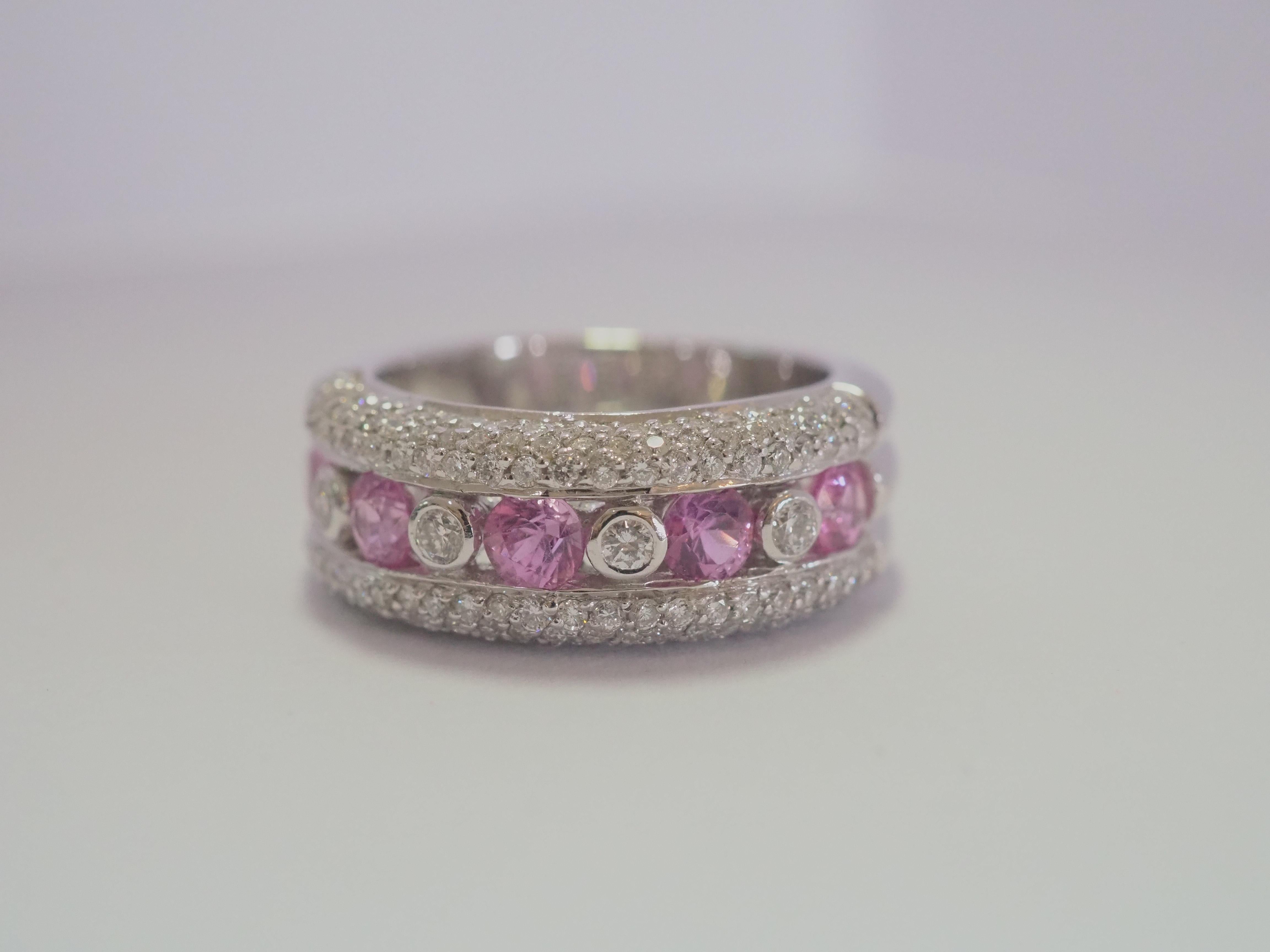 This quality and beautiful cocktail band piece is an 18K white gold fine quality of 5 round cut pink sapphire and diamond ring. 5 bubblegum oval pink sapphires are set meticulously. There are 4 of 2mm of brilliant cut diamonds at decent size and of