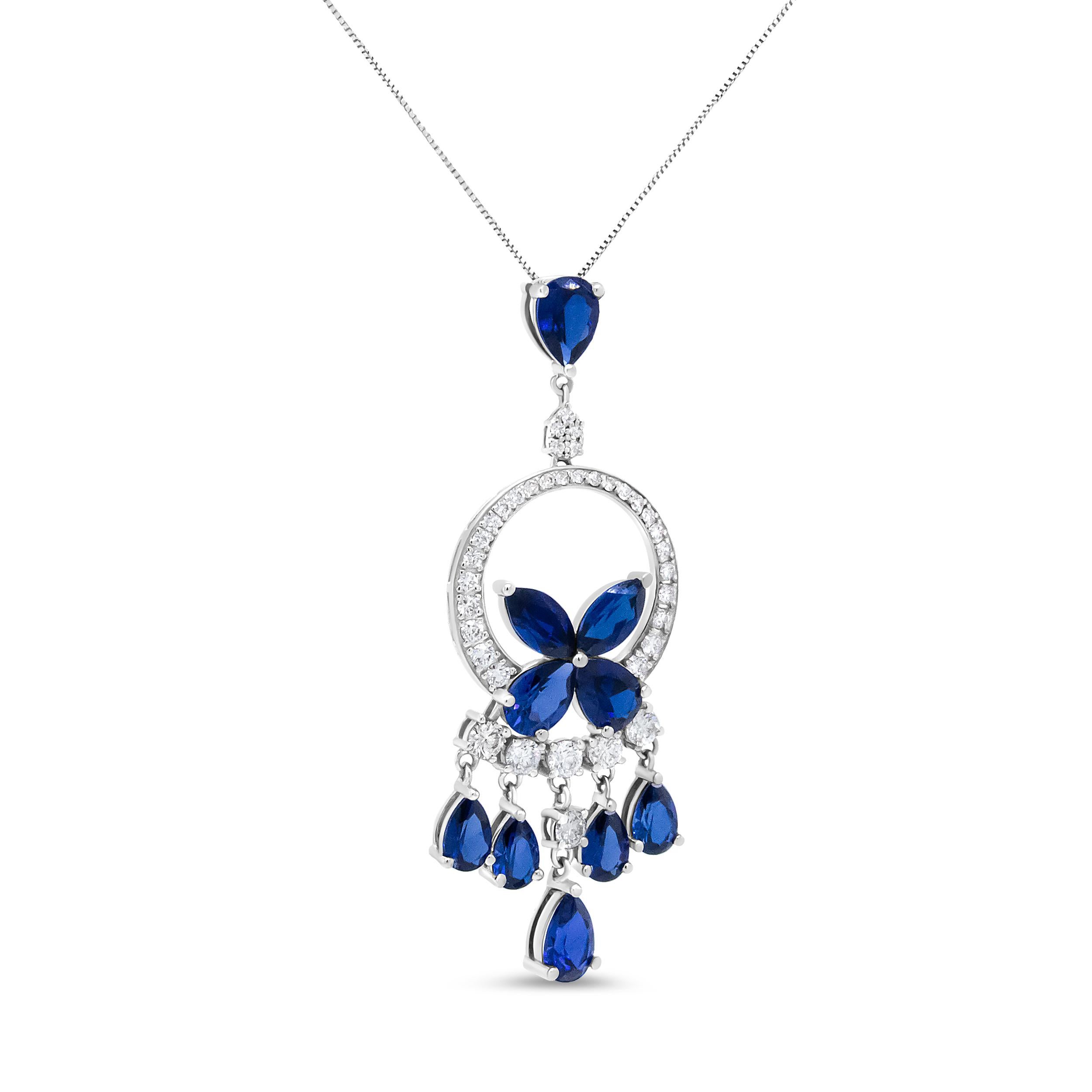 This 18k white gold pendant necklace is a showstopper! It is comprised of a stunning collection of natural gemstones and diamonds that form an openwork silhouette that cascades into a chandelier motif. The bail features a single color-treated blue