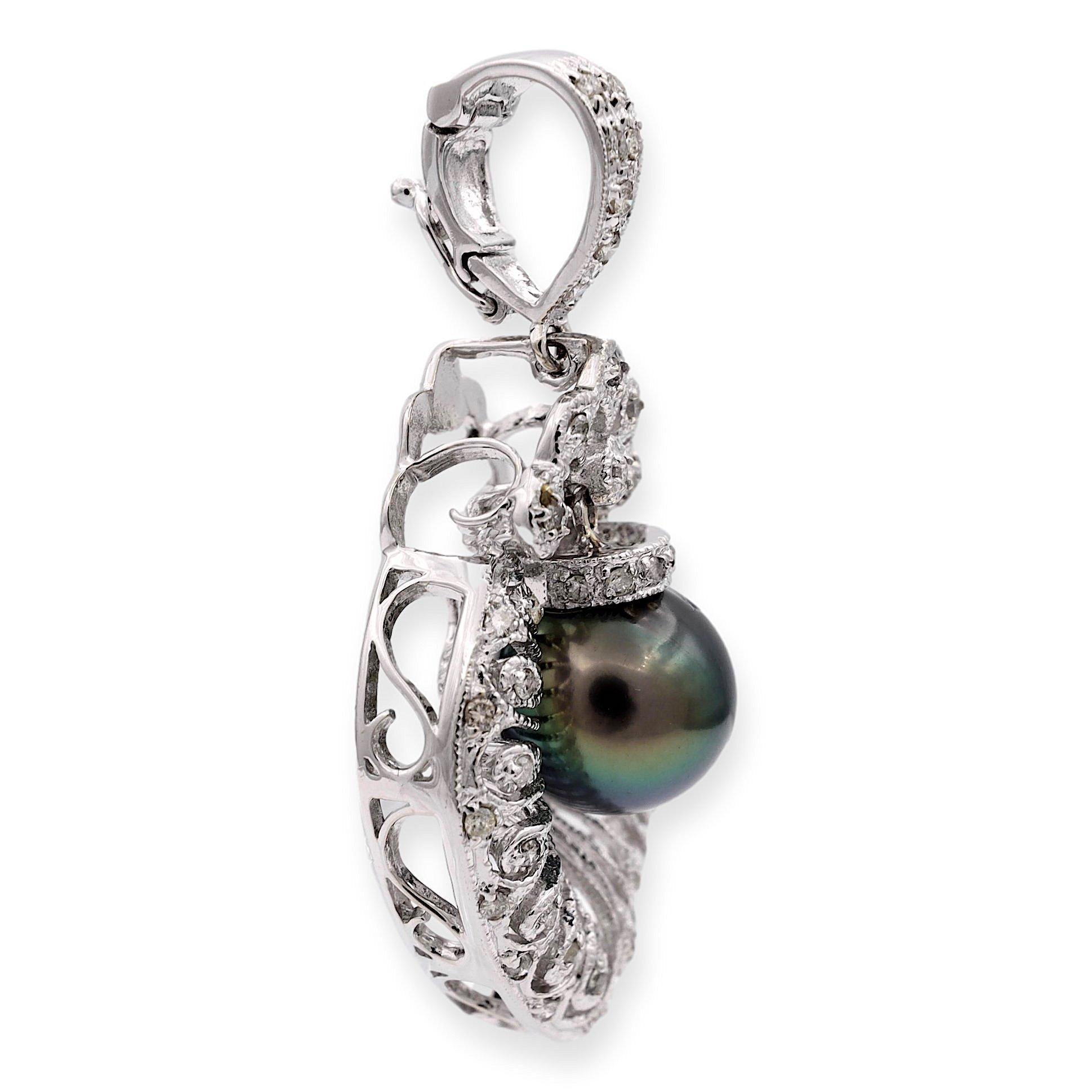 Diamond open scroll-work Pearl Pendant finely crafted in 18 karat white gold. At its center, a lustrous 10mm Tahitian pearl gracefully dangles, surrounded by a dazzling embrace of diamonds on the cap and throughout, weighing approximately 0.25