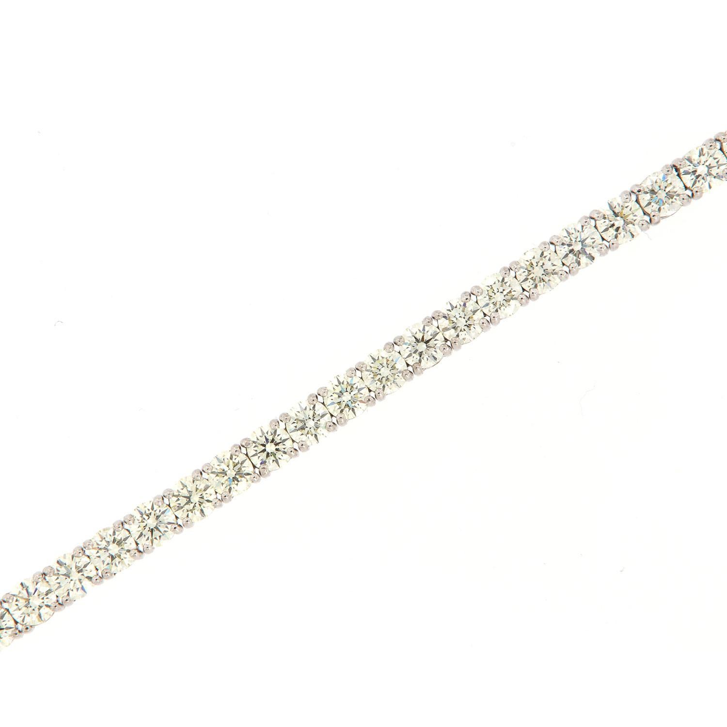 This tennis bracelet features perfectly matched Forty-Four (44) Round shape ideal cut diamonds in a total weight of 11.03 carat set in four (4) prongs 18k white gold. Average color J/K Average clarity VS2 in an excellent luster
The bracelet is 7