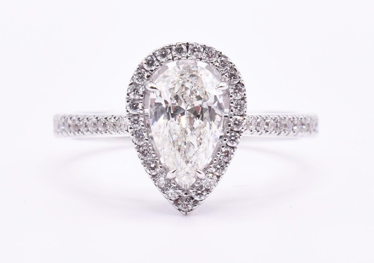 For sale is a fine quality 18k white gold diamond engagement ring, boasting a pear shaped 0.86 diamond to the centre, surrounded by a halo of brilliant cut diamonds, with further pavé set diamond sides. 

Metal: 18k White Gold
Total Carat Weight: