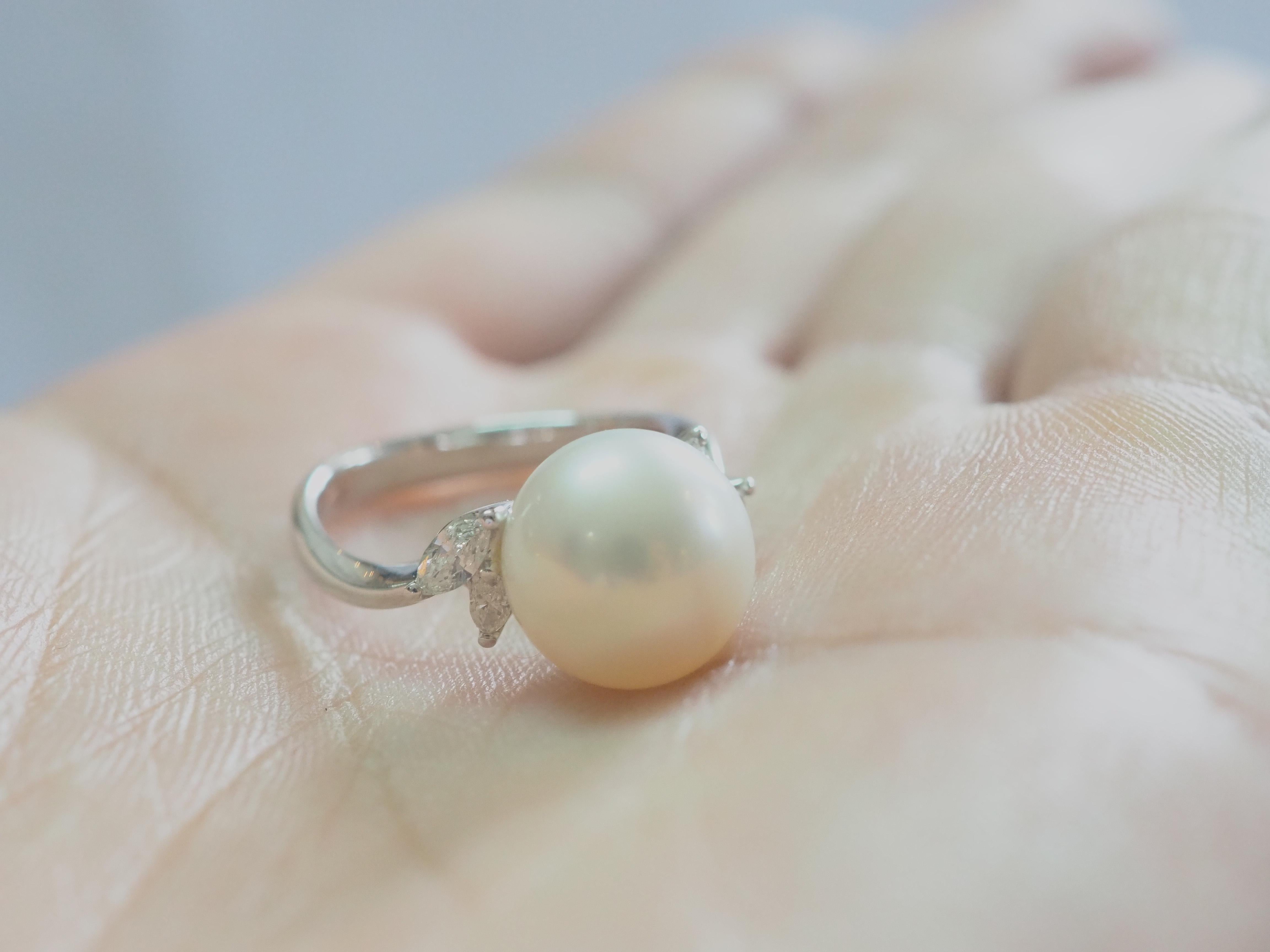 This brilliant 18k gold ring is adorned with a rare and beautiful South Sea pearl! The pearl is perfectly round and has little to no visible blemishes. The diameter of the pearl is 11mm. The accented marquise diamonds are clean and of high quality