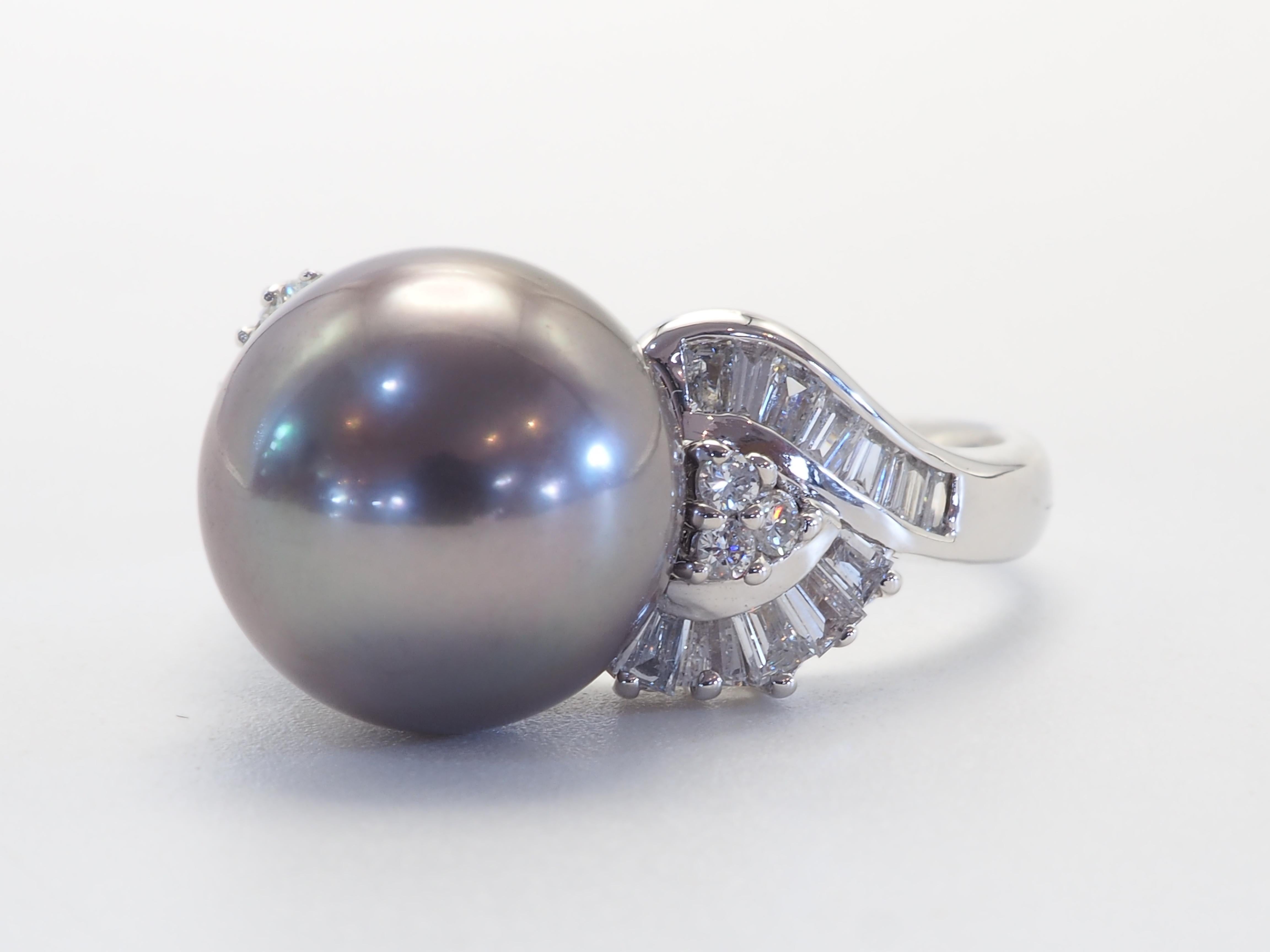 This brilliant 18k white gold ring is adorned with a rare and beautiful Tahiti pearl! The pearl is perfectly rounded and has only slight natural blemishes marks. The diameter of the pearl is 11mm. There are 24 tapered baguette diamonds and 6 round