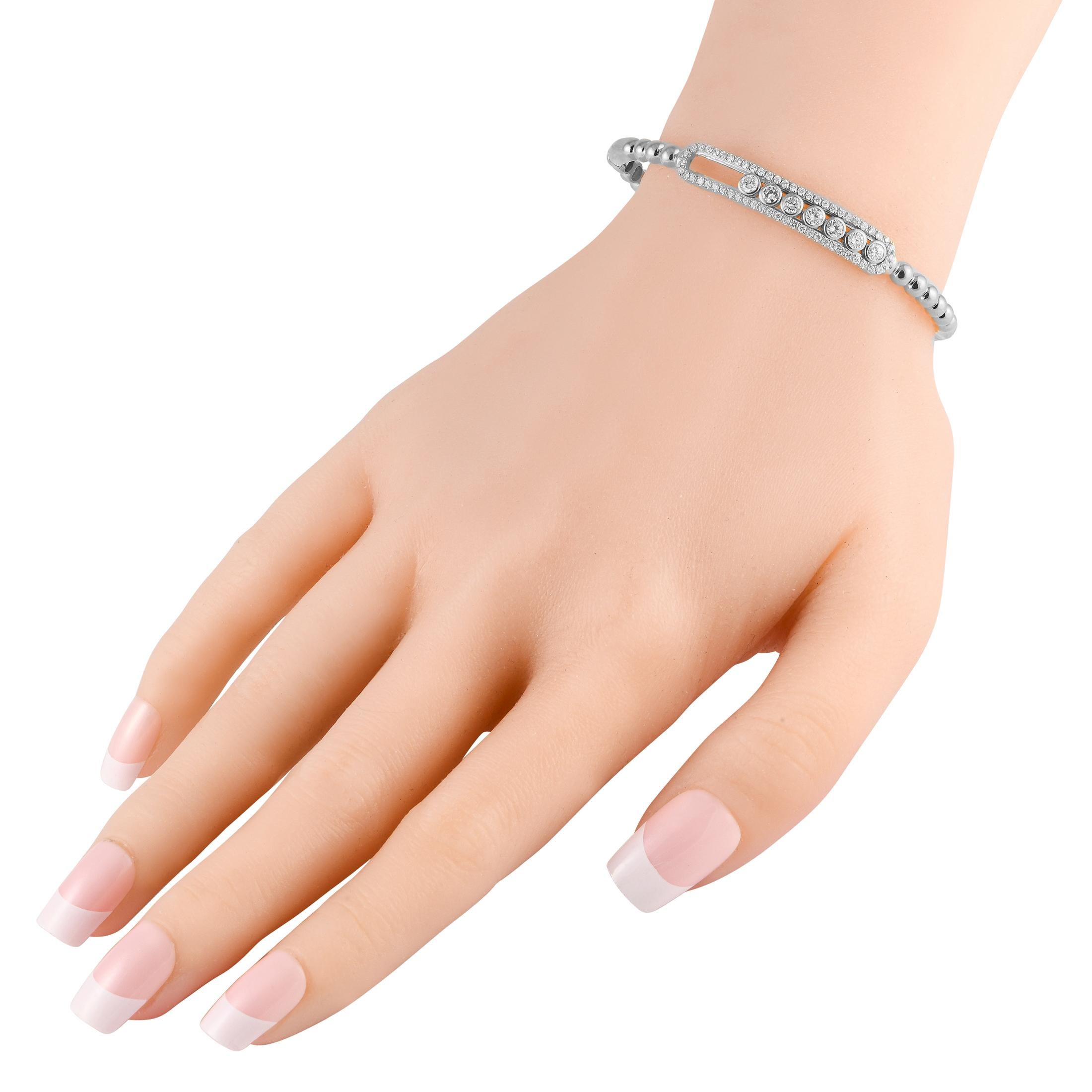 Delicate and dynamic in design, this sophisticated 18K white gold bangle bracelet is an impeccable piece that will never go out of style. Elevated by 1.20 carats of sparkling diamonds, it measures 6.75 long and includes secure tab insert clasp
