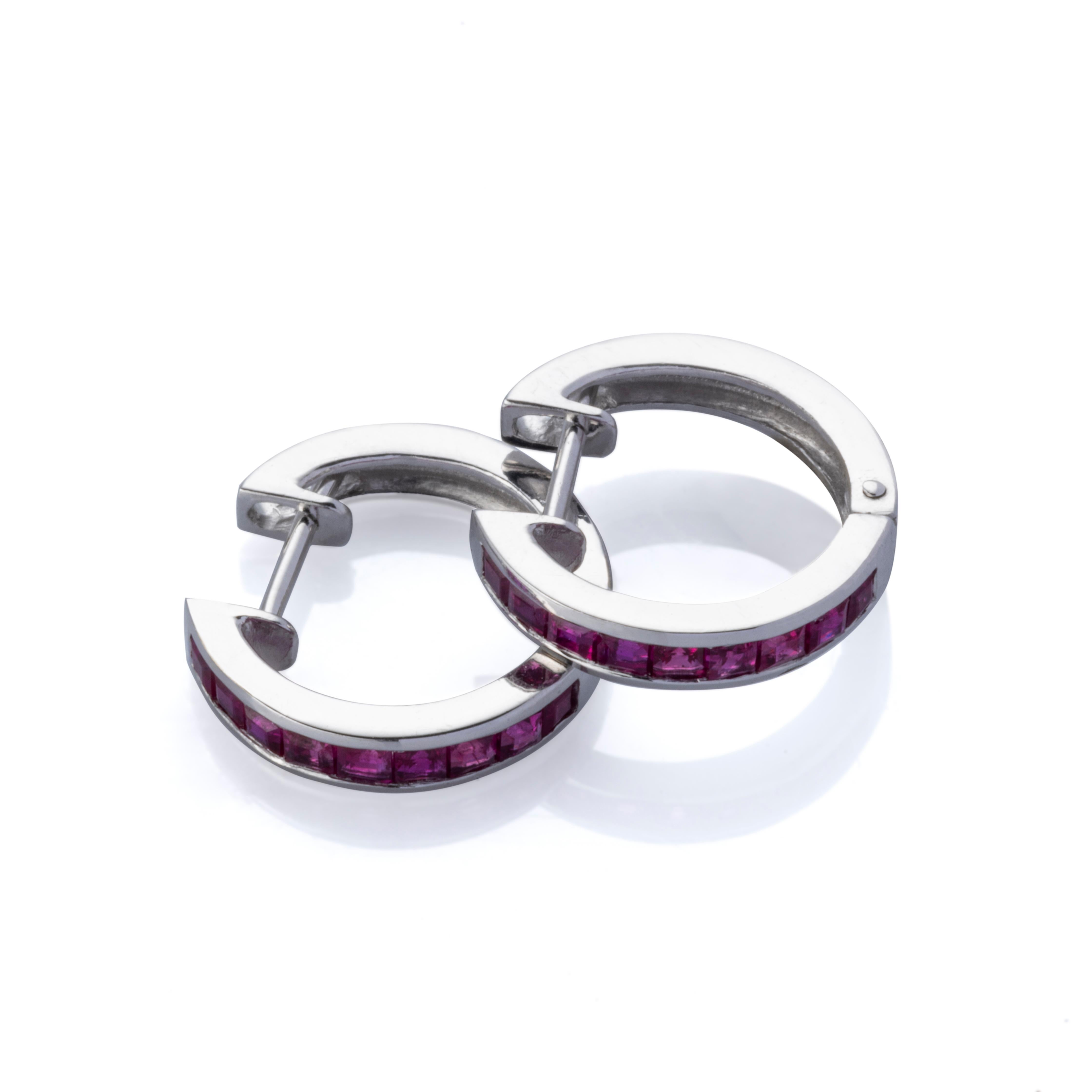 Starting only at 99.
Beautiful and unique earrings made in the early 2000s and has never been worn. The earrings have the unique shape of a hoop omega and is intricately designed. There are 18 squared pinkish red rubies in total and therefore 9 for