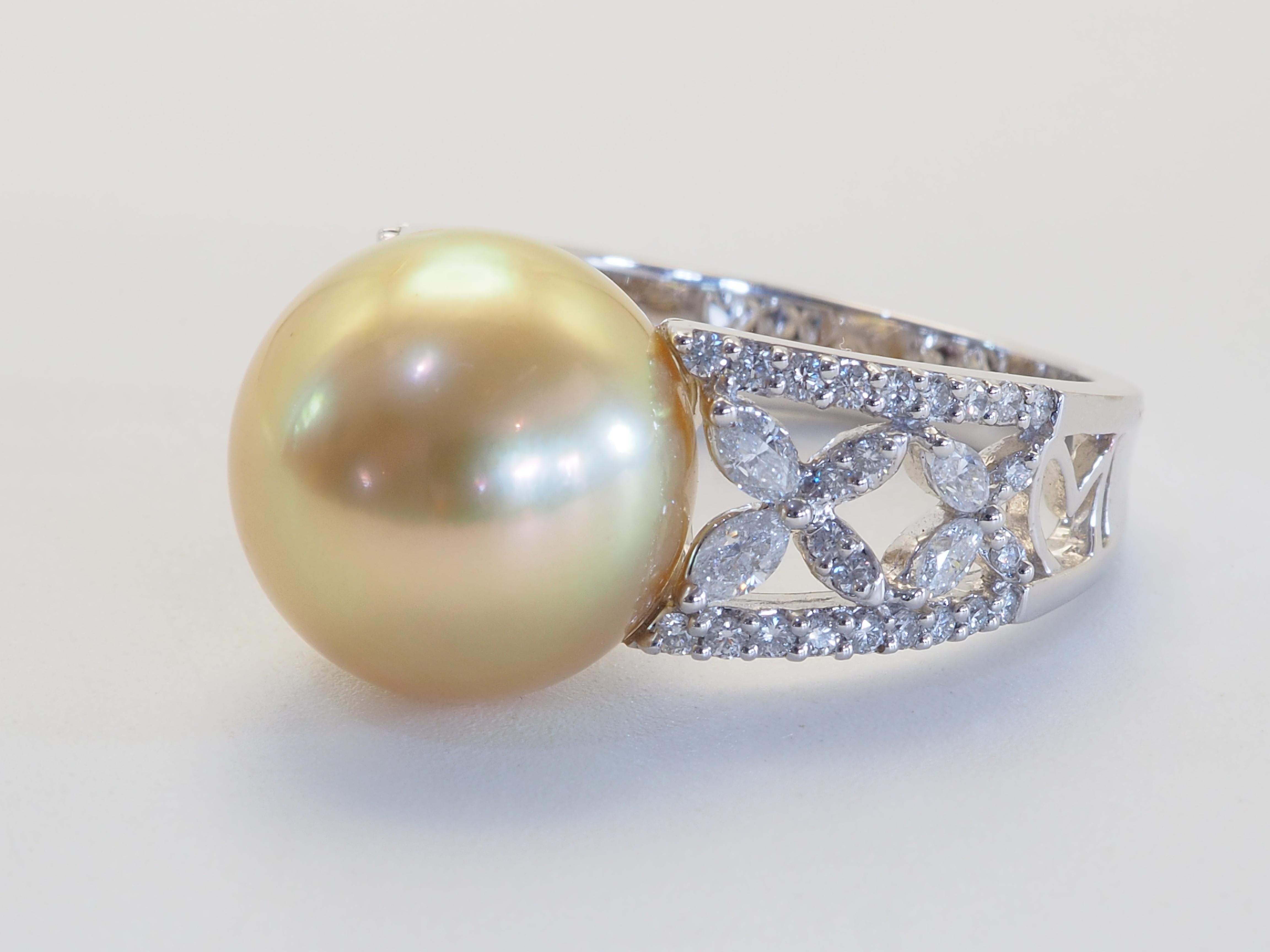 This brilliant ring is adorned with a rare and beautiful South Sea golden pearl! The pearl is perfectly round and has little to no visible blemishes. The diameter of the pearl is 12.75 mm. The accented diamonds are clean and of high quality with