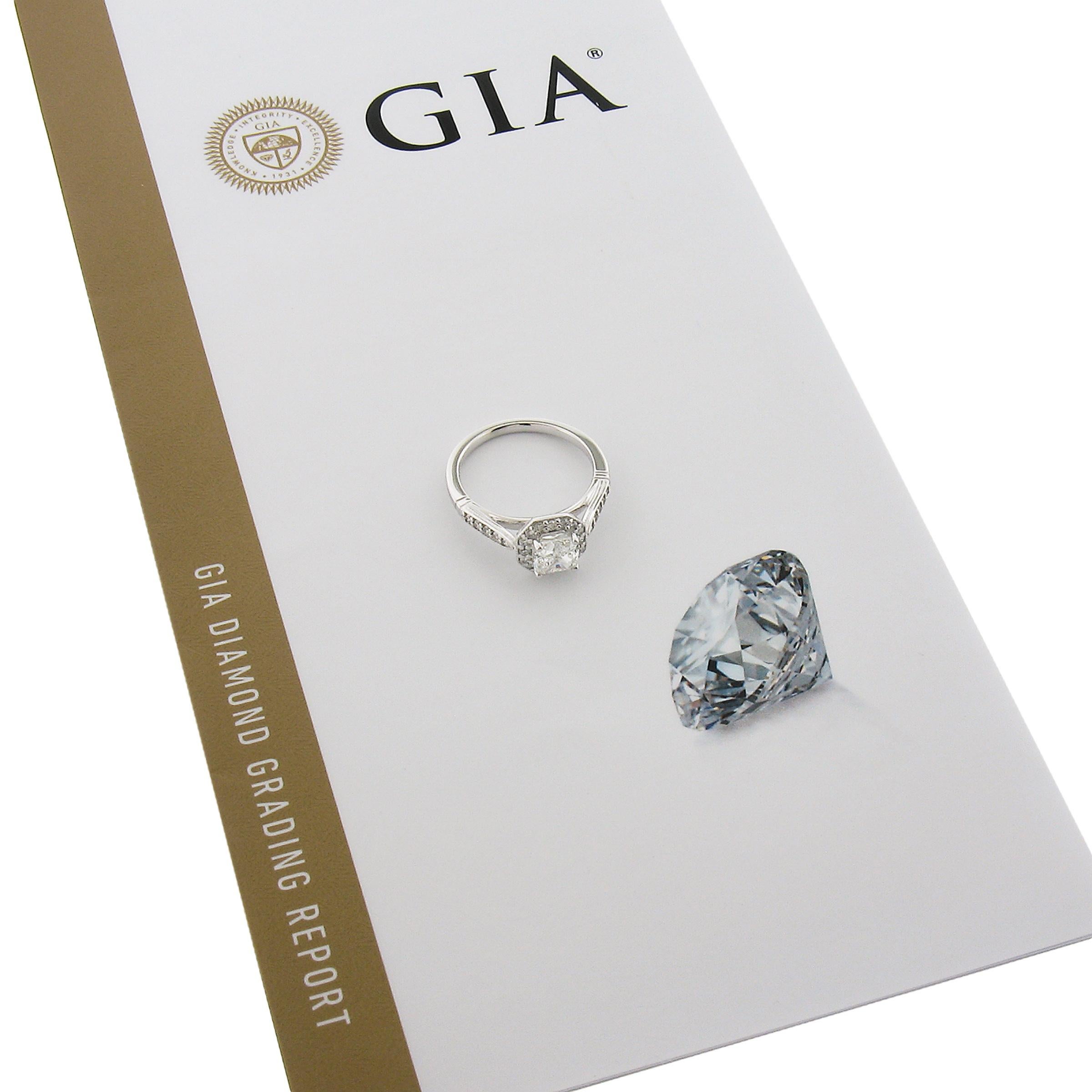 This classically refined diamond engagement ring is crafted in solid 18k white gold and features a fine quality, GIA certified, cushion cut diamond that weighs 1.01 carat with near colorless (I color) and super clean (VS2 clarity). This ring is