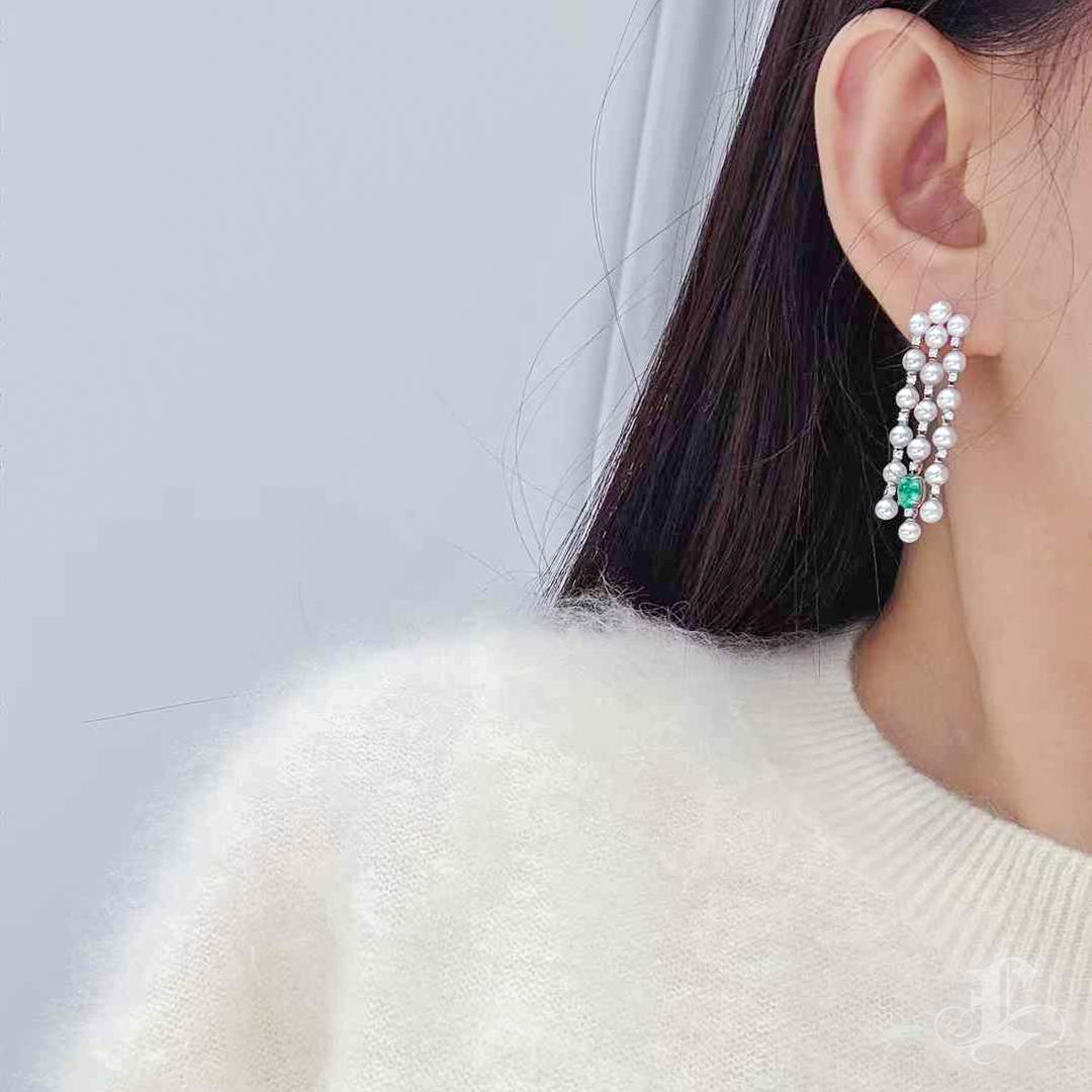 Make a statement of timeless beauty with these exquisite earrings, featuring three graceful rows of luminous Japanese Baby Akoya pearls, celebrated for their perfectly round shape and enchanting aurora-like glow. Complemented by vibrant green