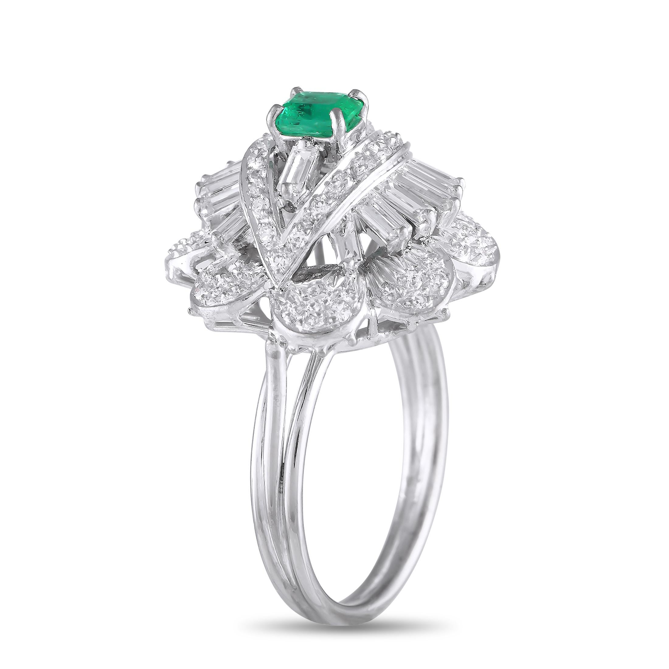 Dazzling Diamonds with a total weight of 1.30 carats allow this ring to effortlessly catch the light. A single 0.53 carat Emerald gemstone serves as a stunning focal point at the center, while an intricate 18K White Gold setting with dynamic