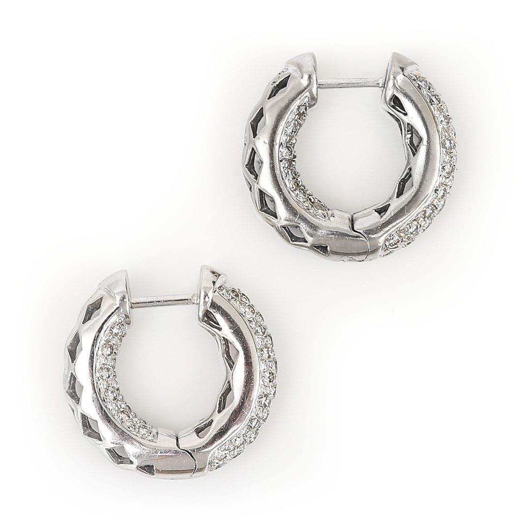 A stylish pair of contemporary 18k white gold hoop earrings with pave-set brilliant cut diamonds. A total of 1.30ct of bright, white diamonds are pave set throughout these attractive huggie hoops. These pre-loved earrings are cleverly designed so