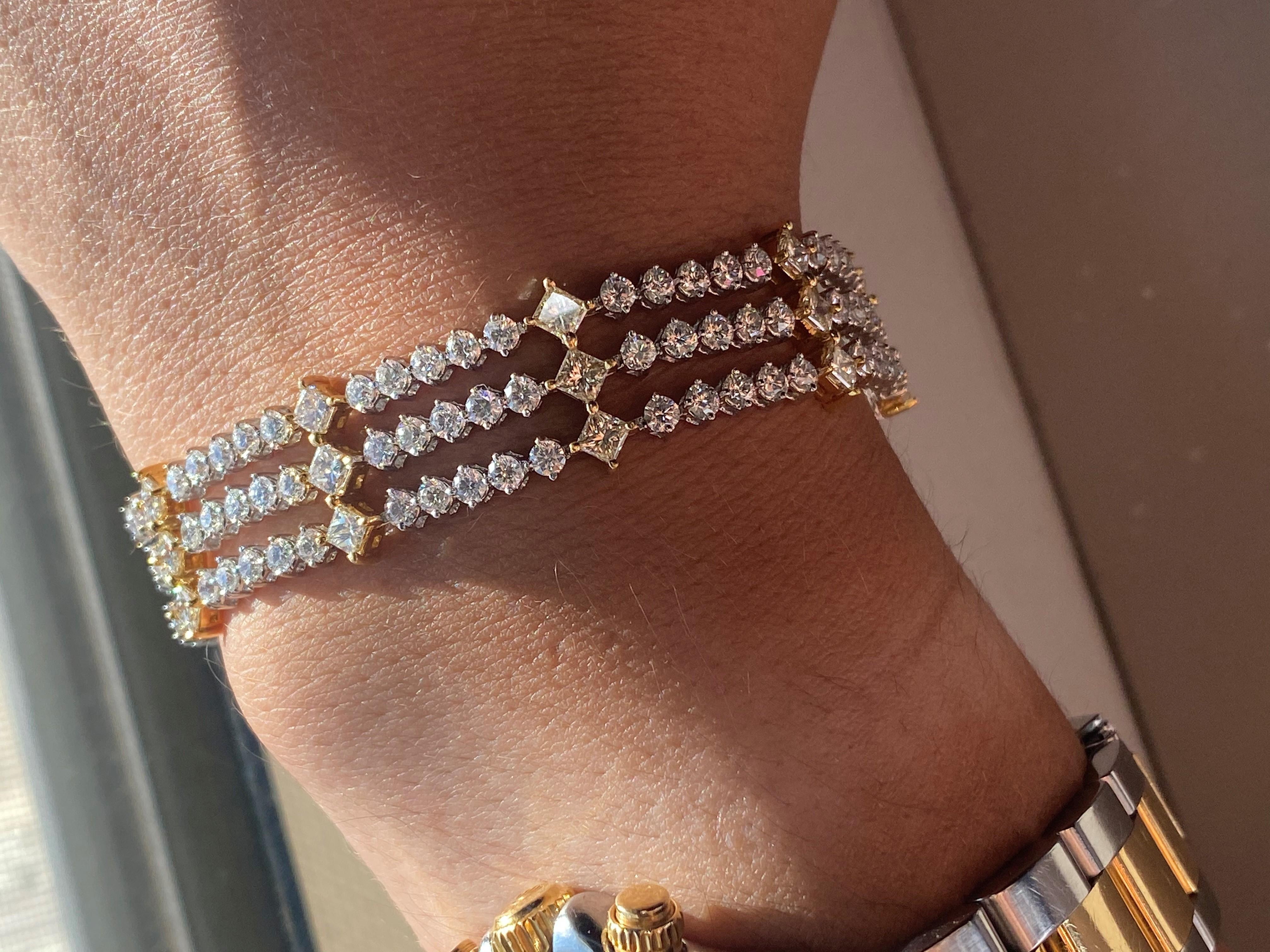 18K White gold, tri row diamond bracelet, features 13.50 Carats of white round brilliant cut diamonds and canary yellow princess cut diamonds. 
