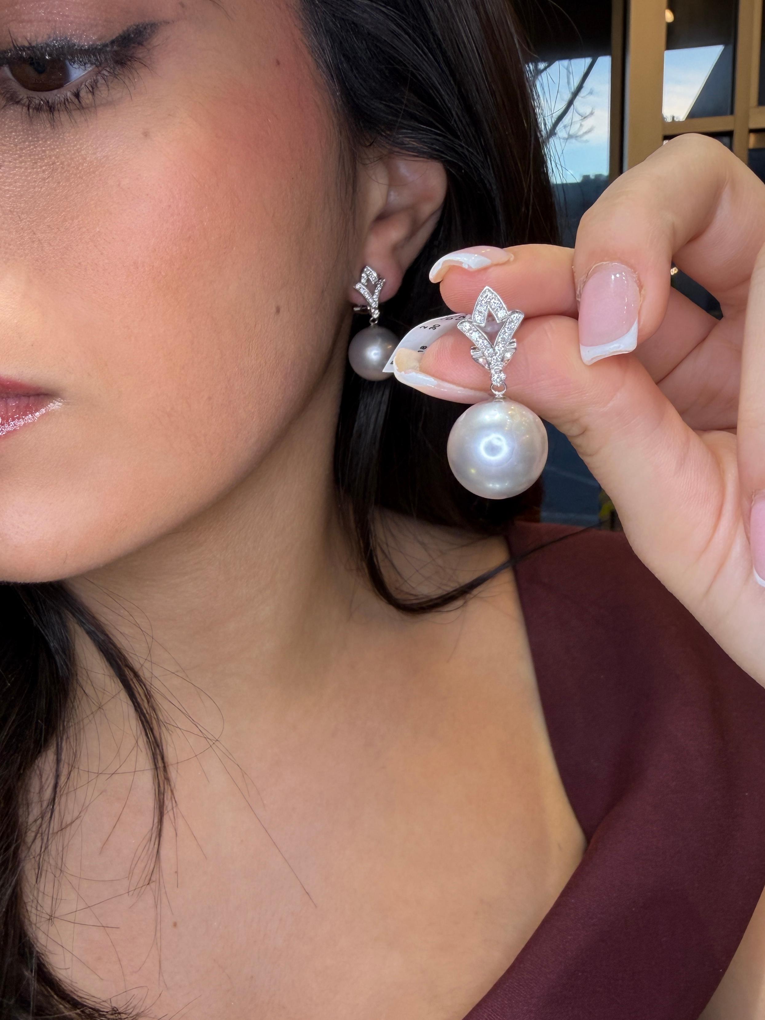 A timeless and elegant pair of 18K white gold South Sea/Tahitian pearl and diamond drop earrings, designed with the refined craftsmanship seen in leading high-jewelry houses. These earrings showcase two magnificent 14.5 mm South Sea/Tahitian pearls,