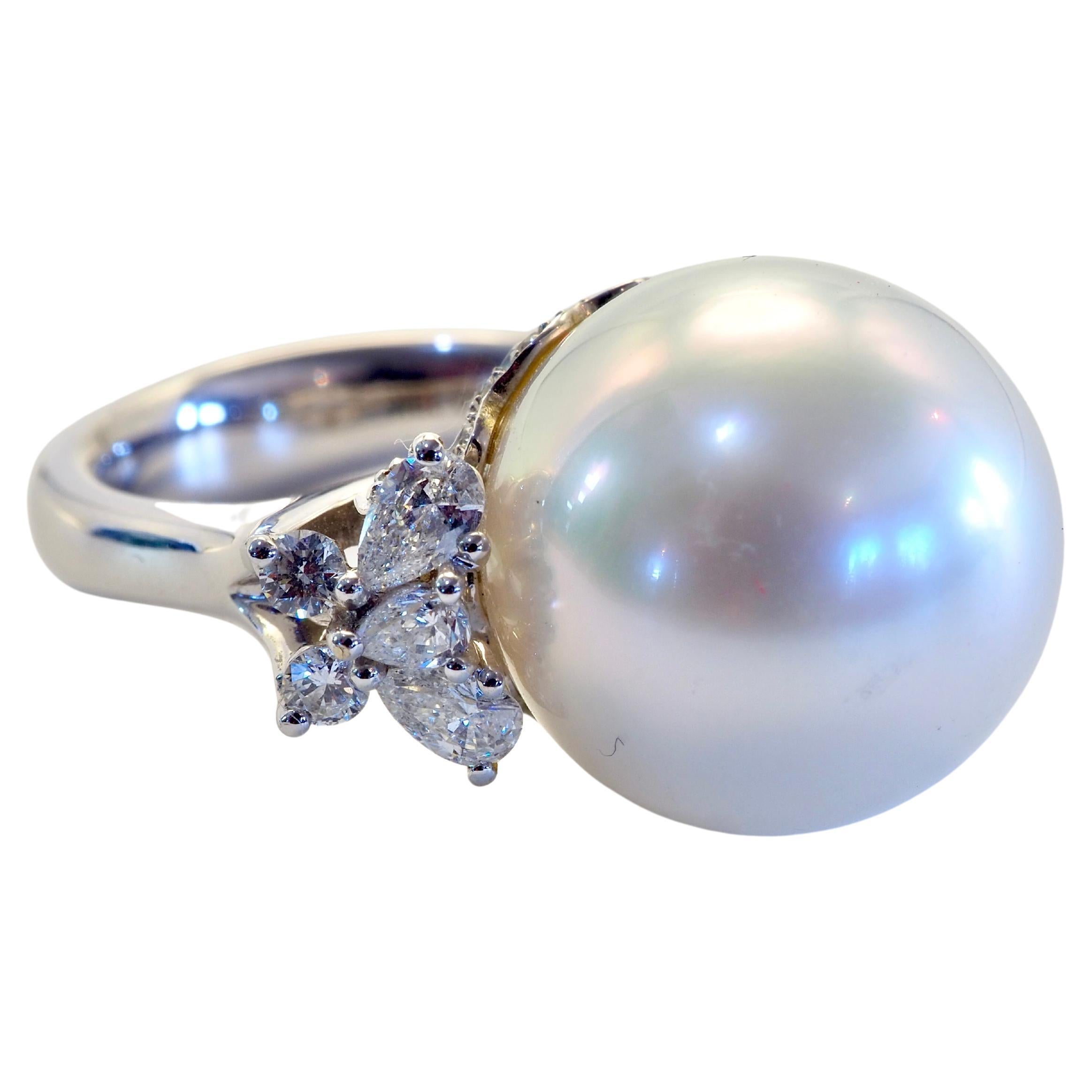 White South Sea Pearl though dainty at 14.7 mm diameter is very shiny and clear as can be. Some natural inclusions and bumps with only by careful inspection. The brilliant and pear cut diamonds follow suit shining brightly together. 
A fine 18k