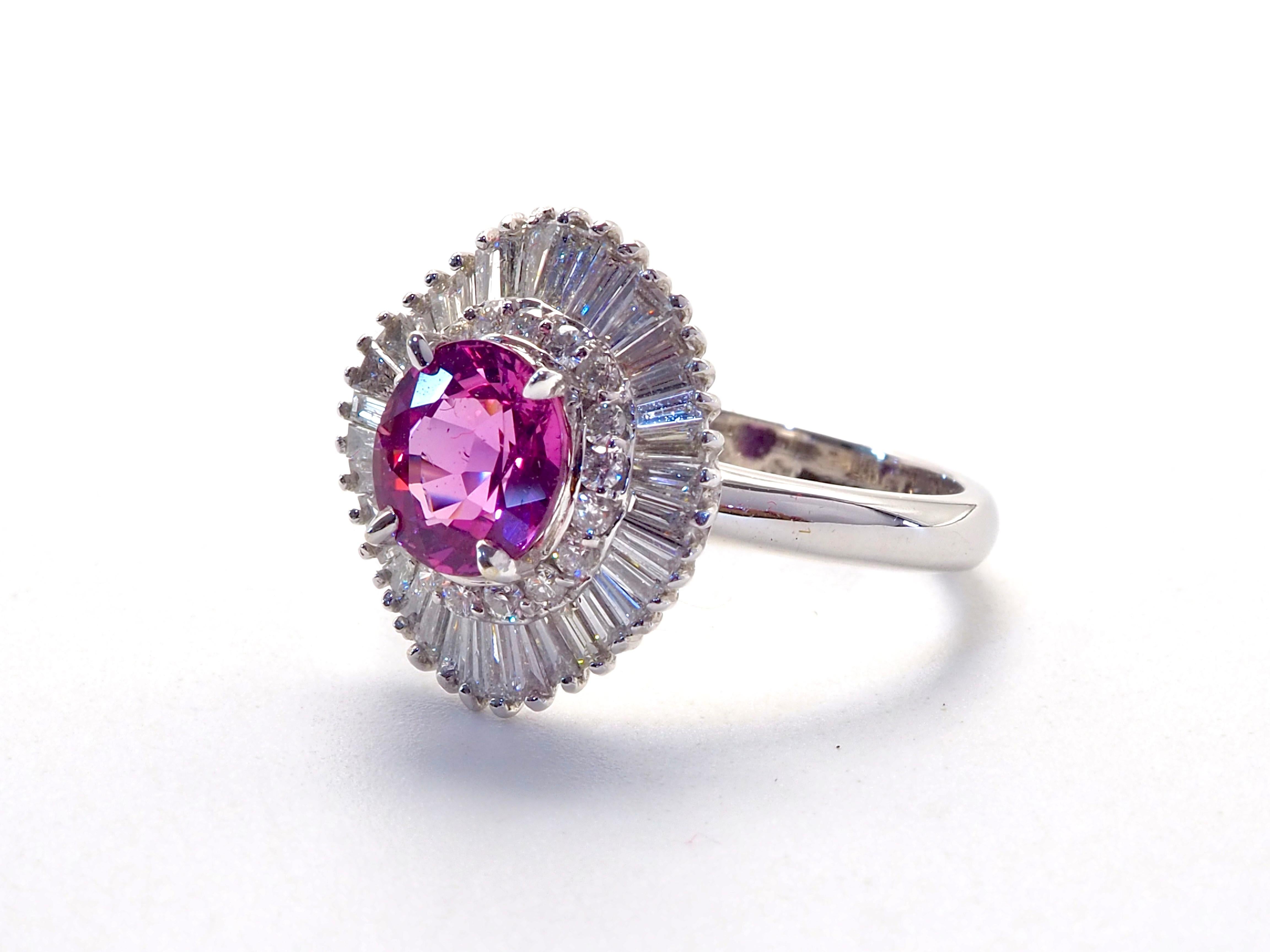  This amazing vintage ballerina statement ring boasts a stunning oval purplish pink sapphire of 1.50 carats. This one-of-a-kind oval cut sapphire is heavily surrounded by high grade natural tapered baguette and round cut diamonds. Immaculate