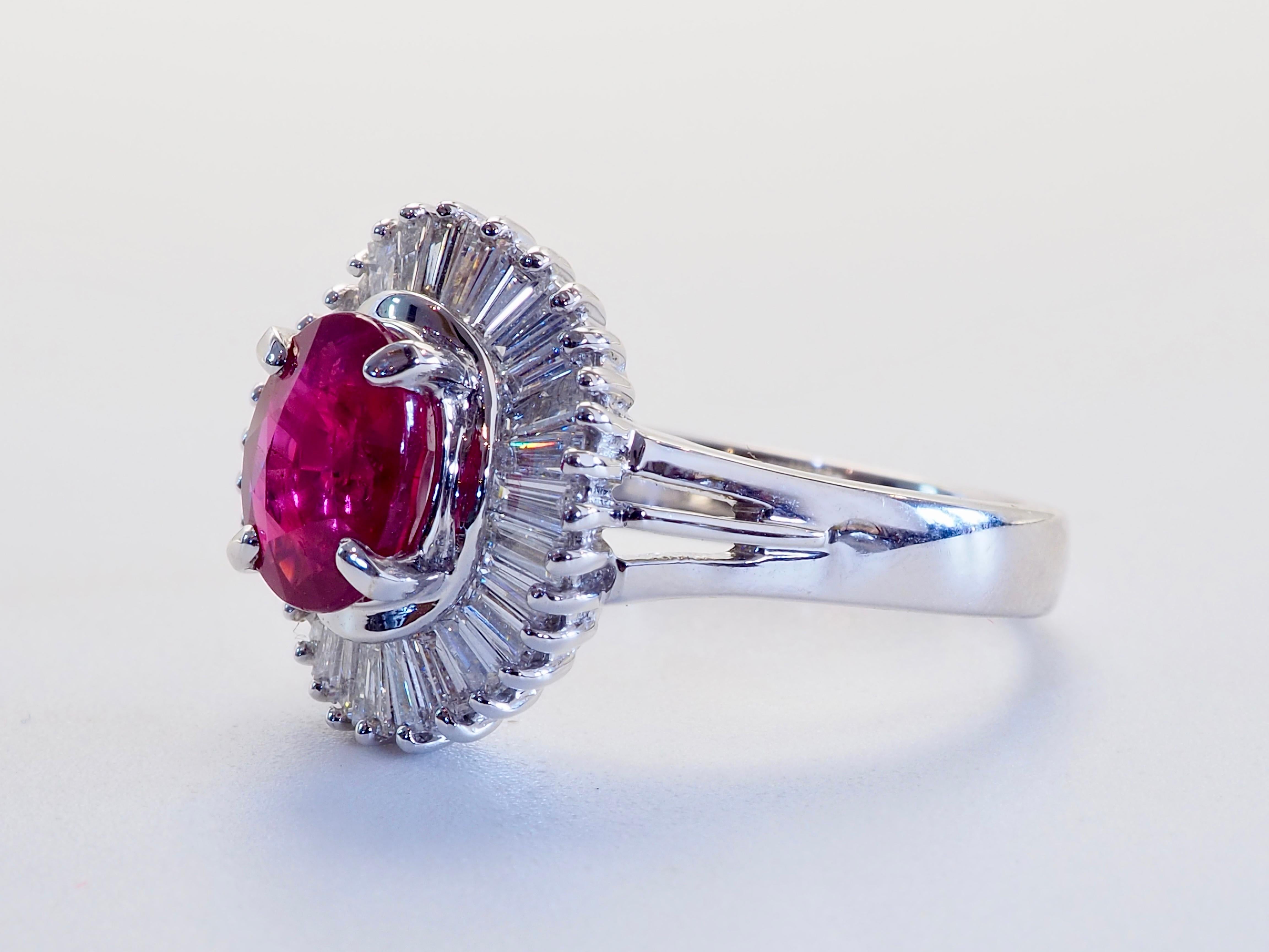  This amazing ballerina statement ring boasts a stunning oval pinkish-red ruby of 1.51 carats. This rare oval cut ruby is heavily surrounded by high grade natural tapered baguette cut diamonds. Immaculate craftsmanship can be seen in very parts of