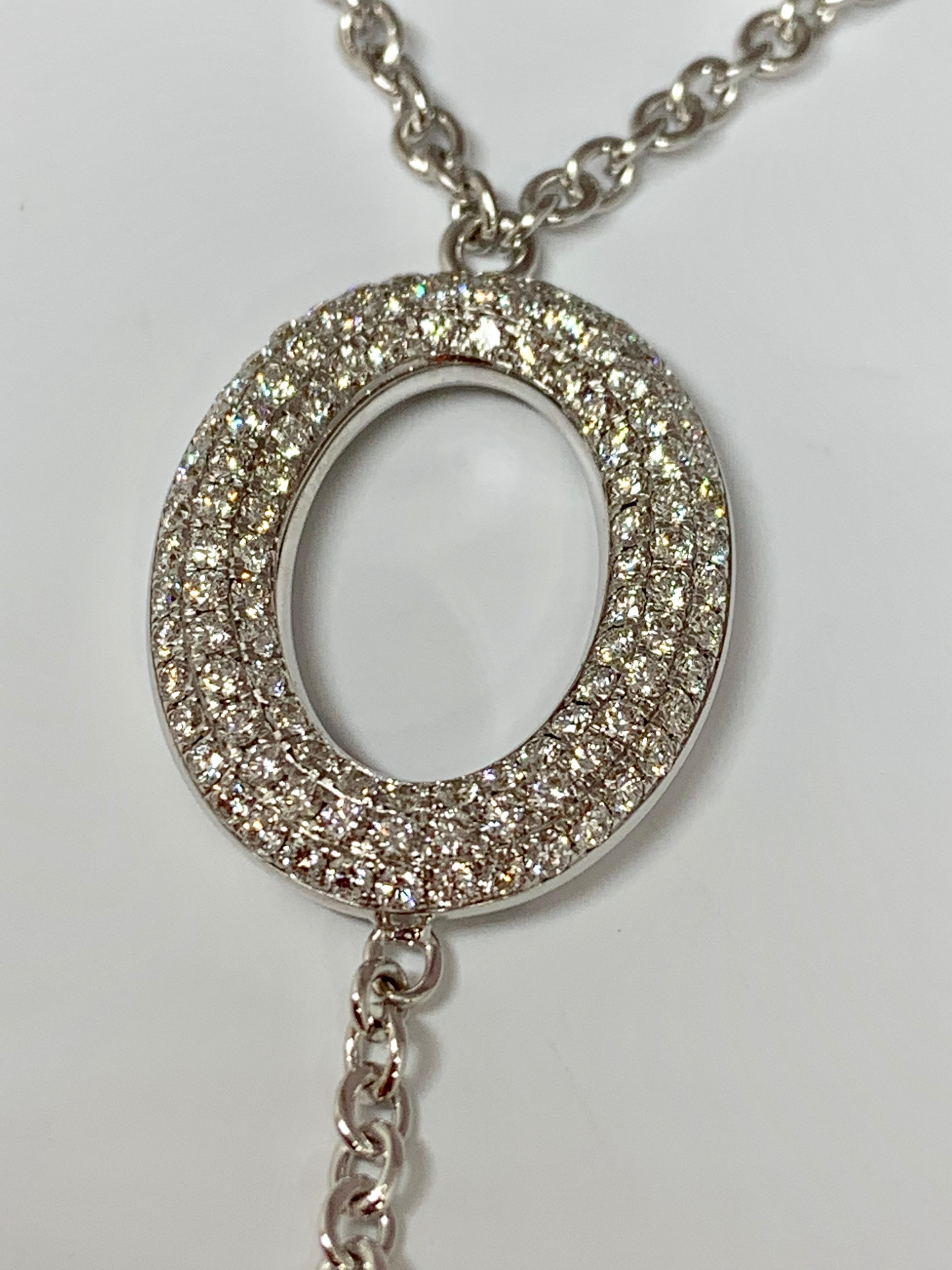 This gorgeous 18K white gold necklace features a triple row diamond studded round pendant holding 1.55 carats of round white diamonds. Its Art-Deco design includes a decorative 18K white gold drop. The necklace includes an 18 inch sturdy cable chain