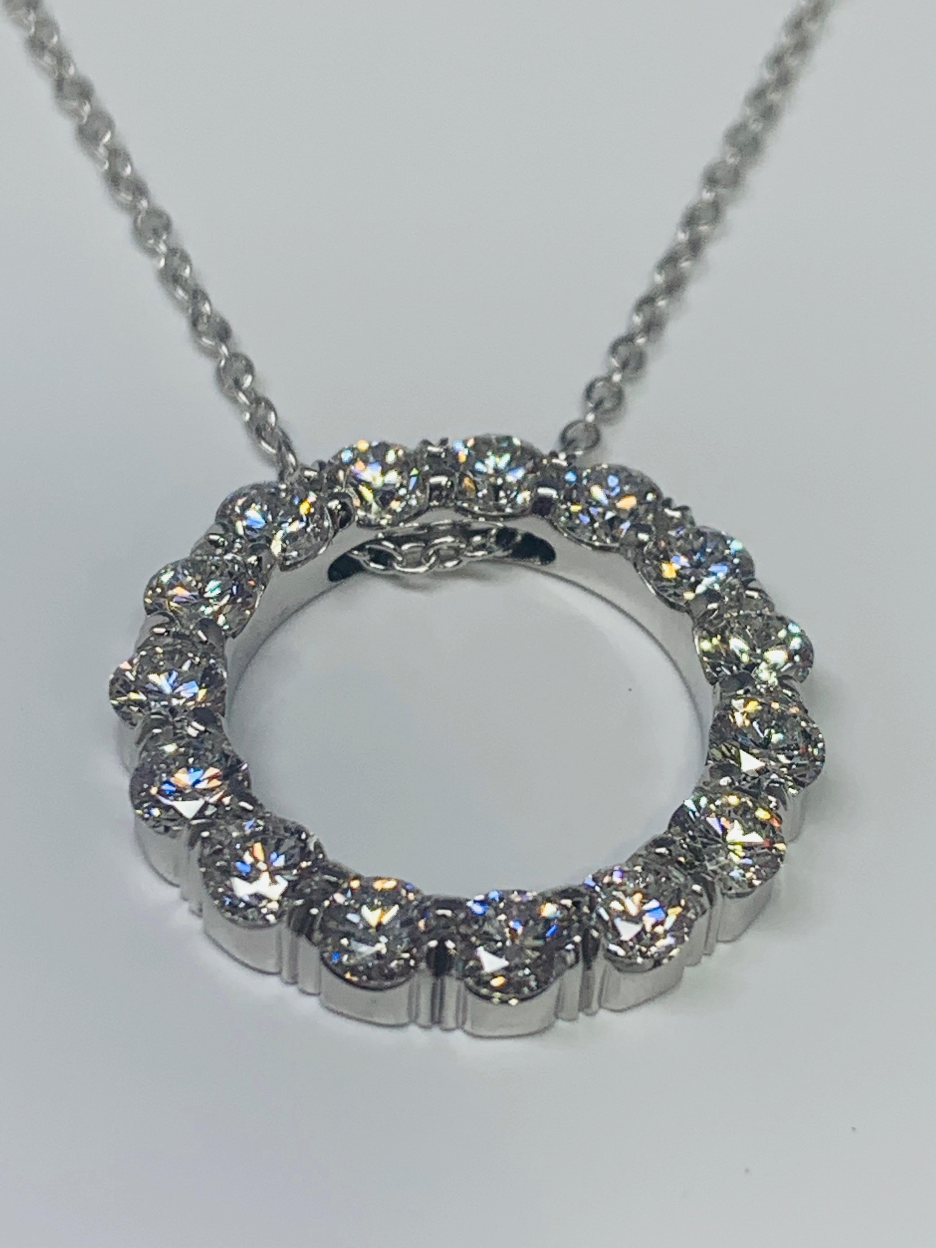 This sparkly necklace features a circular pendant holding 1.65 carats of round white diamonds. The diamond quality is estimated to be G-H/VS-SI. This necklace is made out of hypoallergenic 18K white gold and includes 1 millimeter cable chain that is