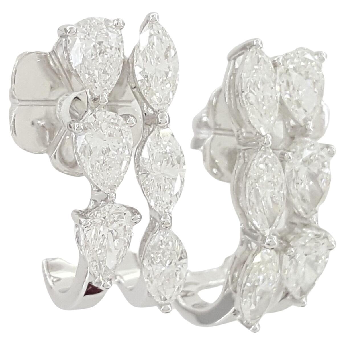  18K White Gold 1.7 ct Pear & Marquise Cut Diamond Drop Earrings.
The earrings weigh 7.6 grams, measuring 17.5 mm high x 6 mm wide, there are 6 Natural Pear Brilliant Cut Diamonds weighing approximately 0.92 ct, E-G in color, VS1-VS2 in clarity.
6