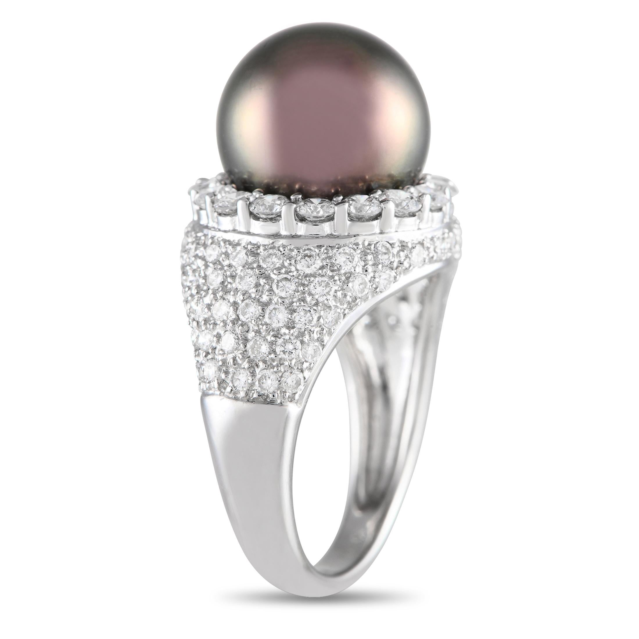 This ring is sure to have heads swiveling. Presented in 18K white gold, the band has a tapering profile, a polished finish on the bottom shank, and a wide, pav-set upper half. Nestled on a bed of 1.72 carats of diamonds is an 11.7mm pearl with a