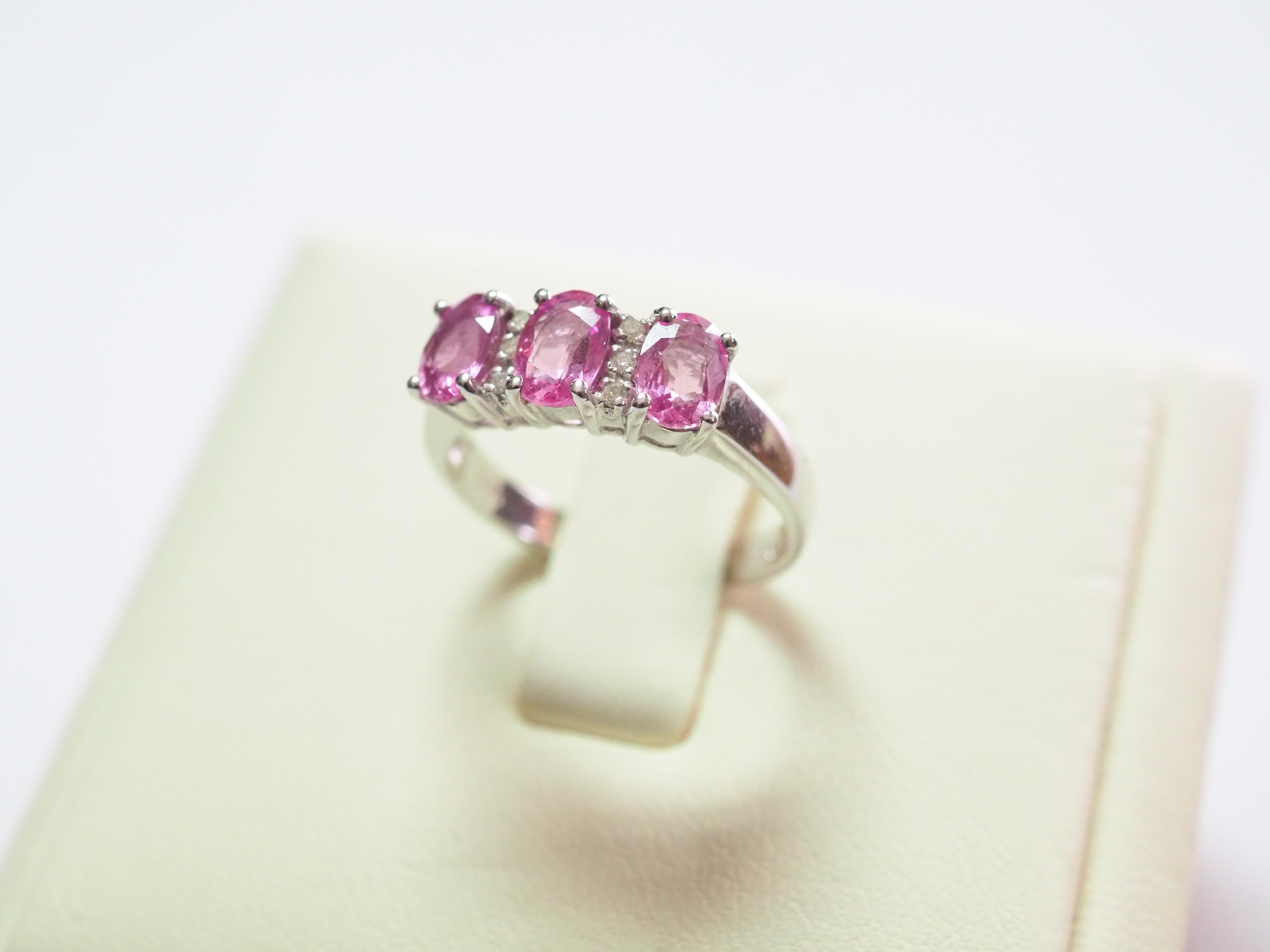 This quality and beautiful engagement piece is an 18K white gold fine quality pink sapphire and diamond ring. 3 bubblegum oval pink sapphires are set meticulously and all the same size with matching colors. There are 4 of round cut diamonds which is