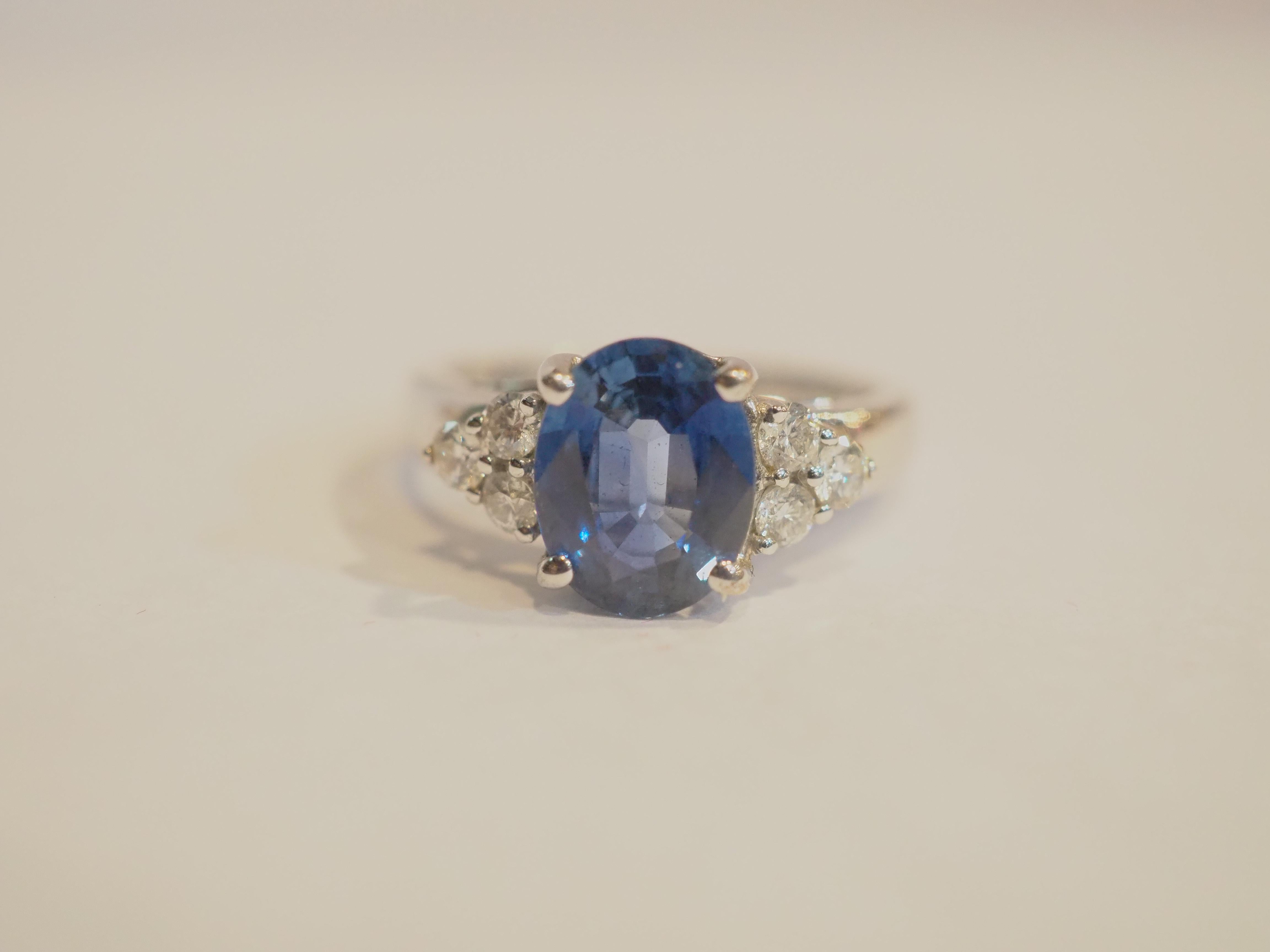 This beautiful engagement ring boasts a very stunning eye clean blue sapphire! The sapphire is an oval cut and is very clear with good saturation of blue color. There are 6 round 2mm brilliant diamonds accenting the ring. The diamonds are of good