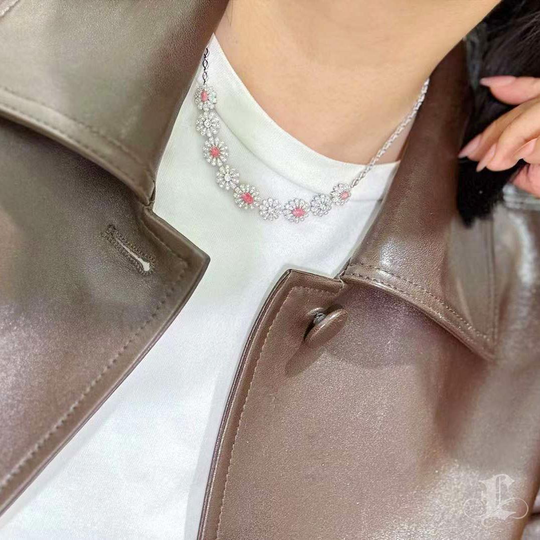 Delicately regal, this diamond necklace features a garden of floral motifs set with five natural light pink conch pearls, totaling 2.0 carats. Each pearl is embraced by layers of sparkling diamond petals—1.9 carats of SI-quality brilliance—forming a