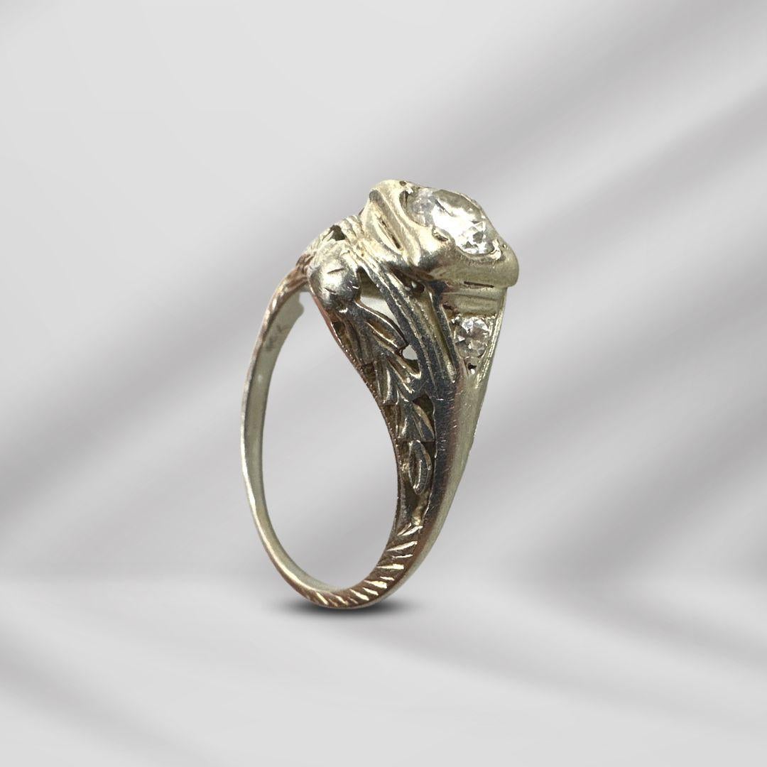 Behold a timeless treasure—a marked 18K white gold diamond ring that whispers tales of a bygone era. This exquisite piece, with an inside diameter of 0.60 inches and a size 5 fit, transcends the boundaries of mere jewelry, carrying with it the