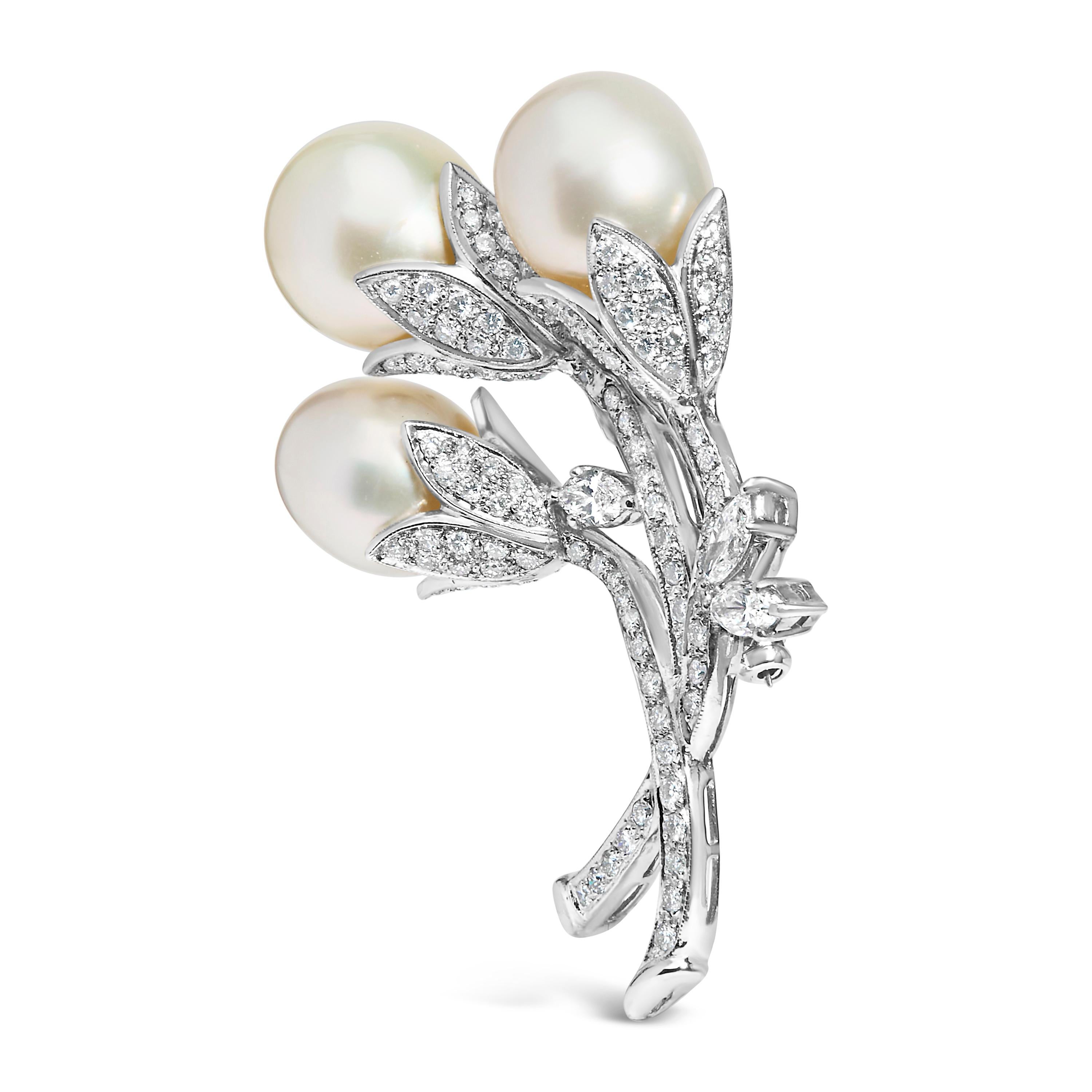 Discover the epitome of luxurious sophistication with this exquisite brooch, masterfully crafted from rhodium-plated 18K white gold in a beguiling floral motif. At the heart of this enchanting piece are three cultured South Sea pearls, sourced from