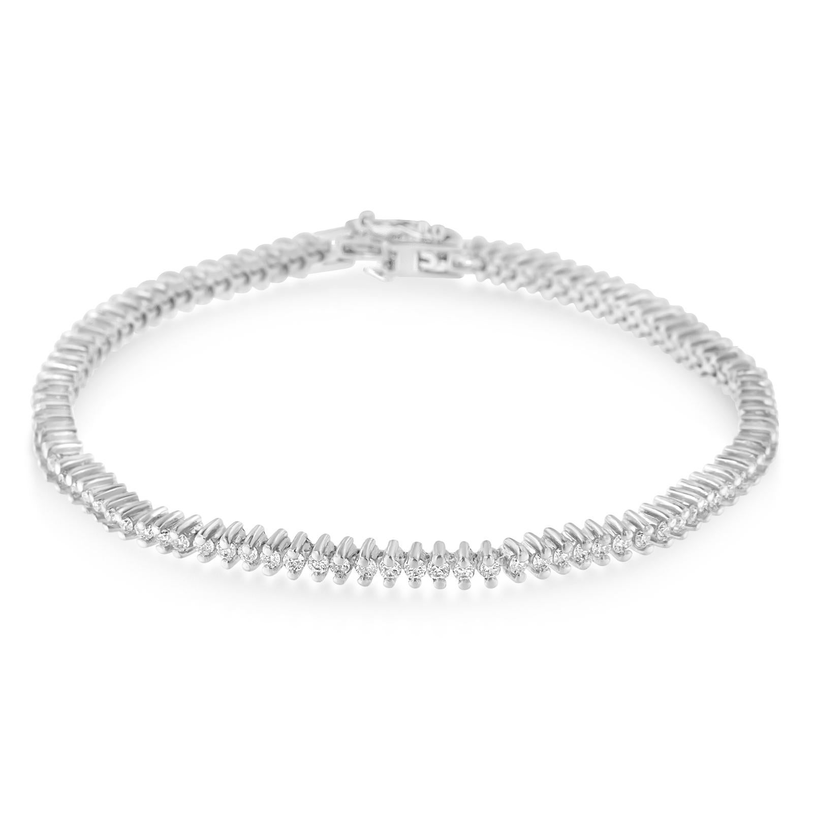 There's a timeless quality to this bracelet. Maybe it's the dazzling display of diamonds set in 18-karat gold... or maybe it's the way her face will light up every time she wears it. Comes with 94 round-cut diamonds, set in 2 prong 18k white gold