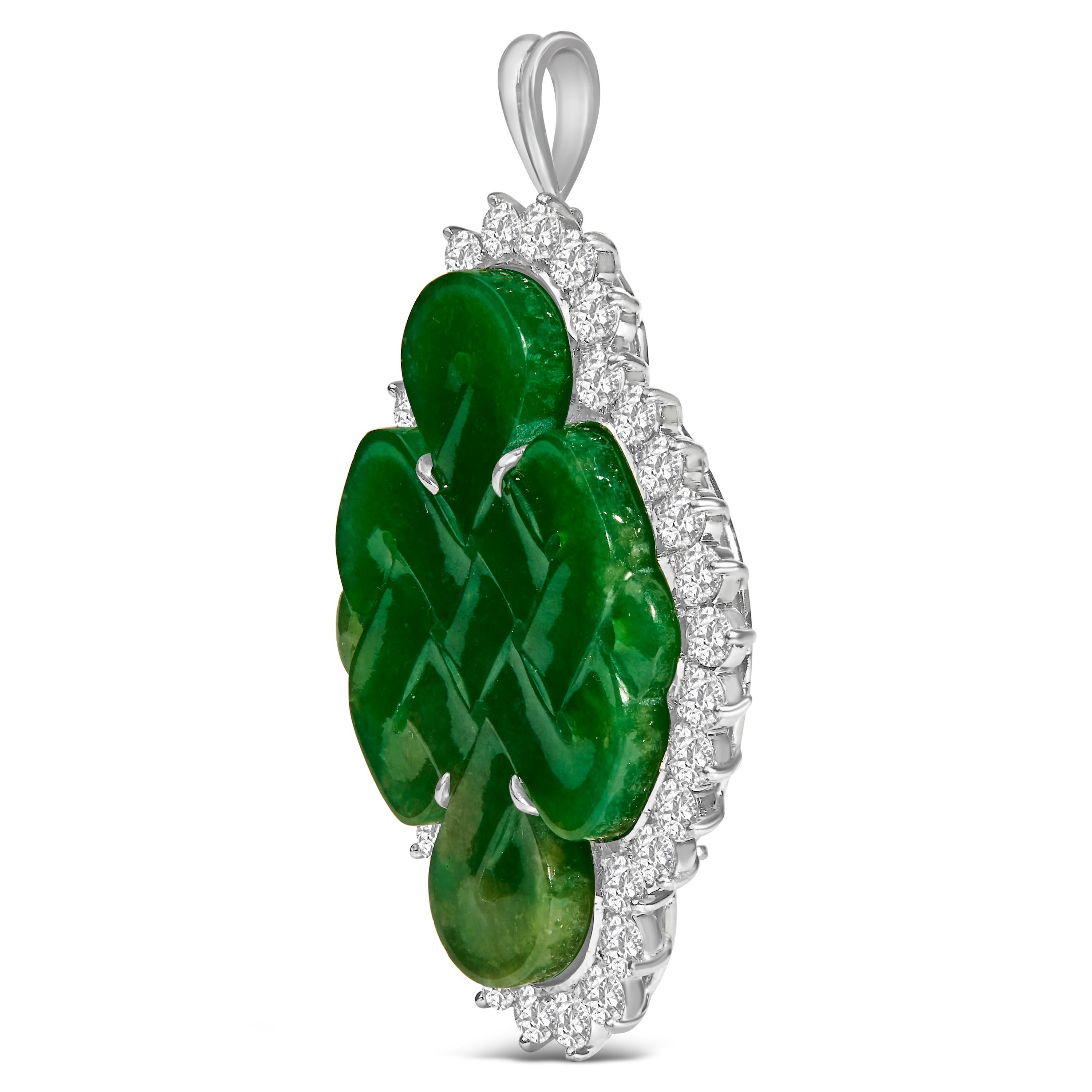 In an epoch where elegance intertwines with versatility, this masterfully crafted 18K white gold brooch and pendant emerges as a paragon of sophistication. Adorned with a natural, intricately carved jade shield that whispers tales of antiquity and
