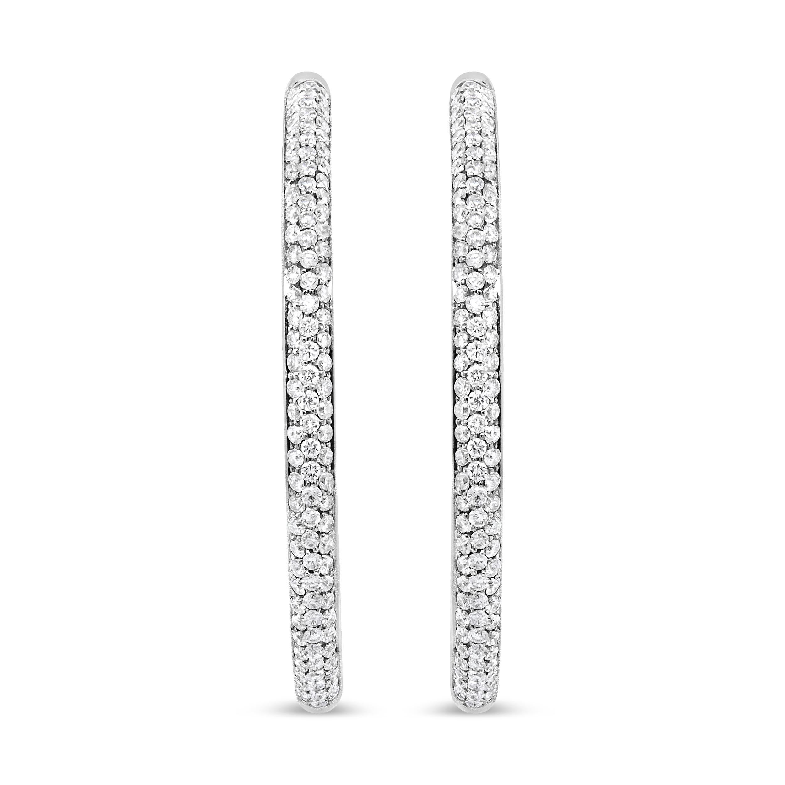 A glamorous take on a classic design, these breathtaking diamond hoops are crafted in luxurious 18k white gold that will sparkle on your earrings. The gold reflects beautifully on the stunning VS1-VS2 clarity diamonds in a round-cut design. The