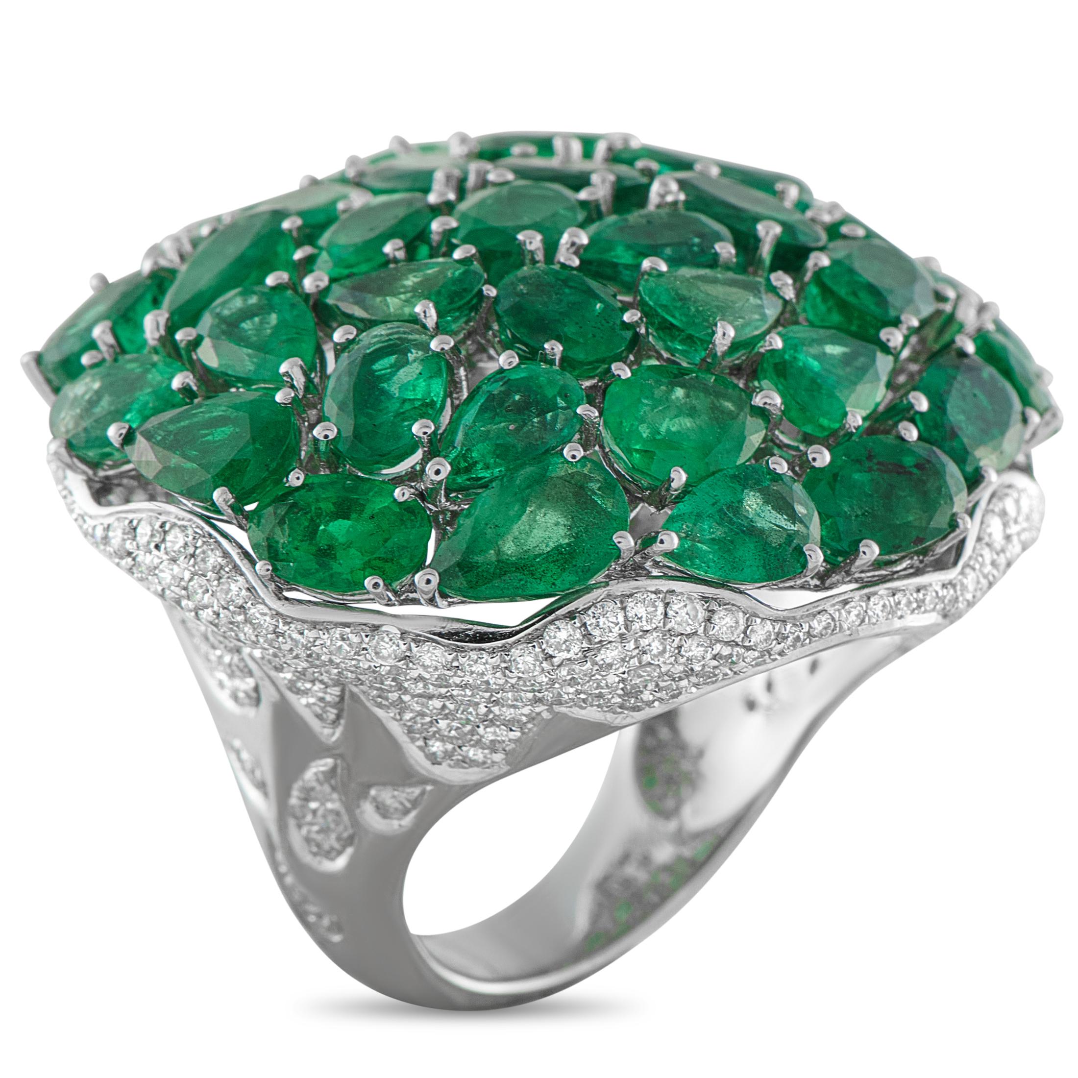 A dazzling array of Emerald gemstones totaling 18.19 carats cover the top of this breathtaking ring. Bold and incredibly impressive, inset Diamond accents totaling 2.03 carats add a touch of extra sparkle to the domed setting. Crafted from 18K White