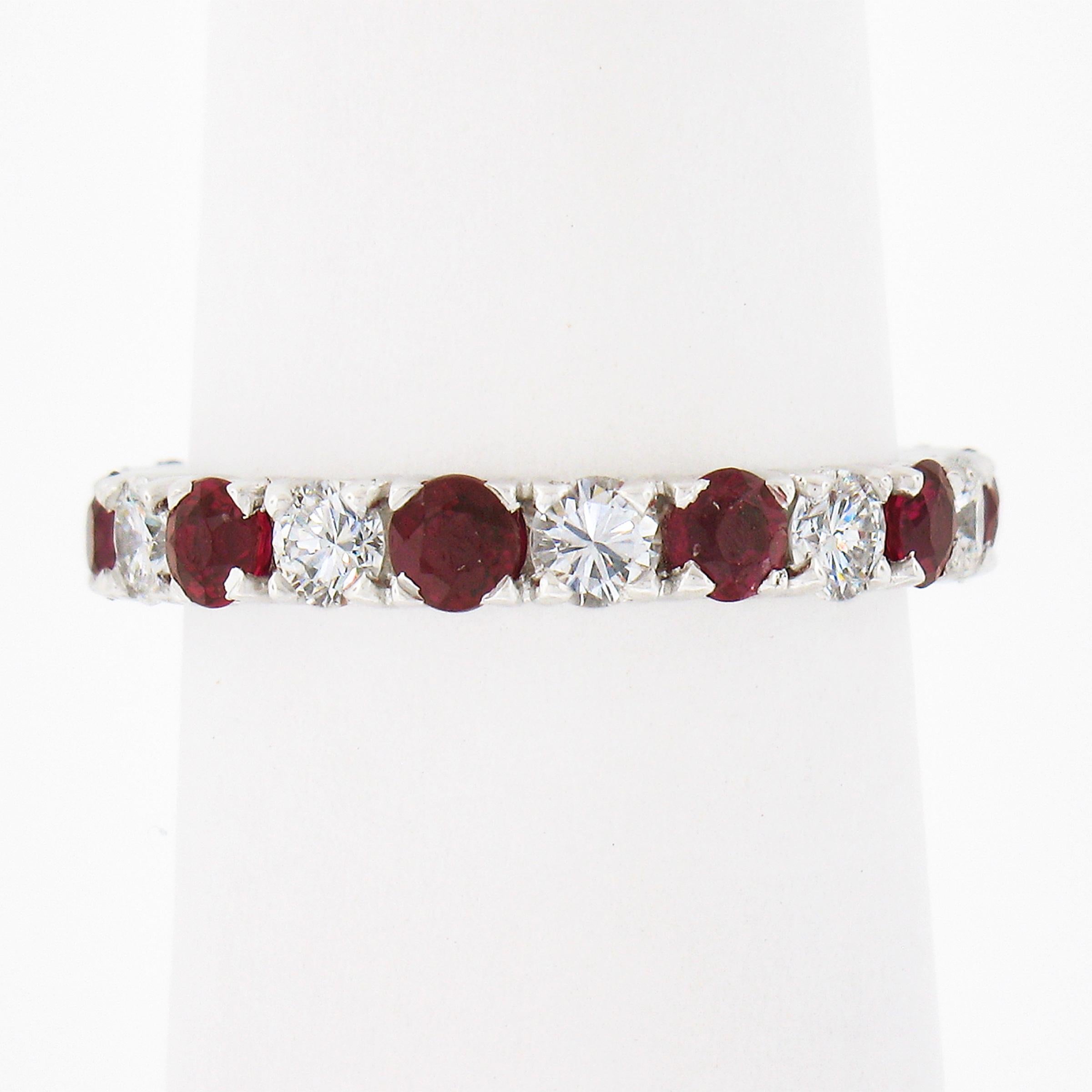 This lovely vintage ruby and diamond eternity band/ring is crafted in solid 18k white gold. It features fine rich red rubies that alternate with the fiery and brilliant diamonds, giving the ring this incredible color contrast between the stones that