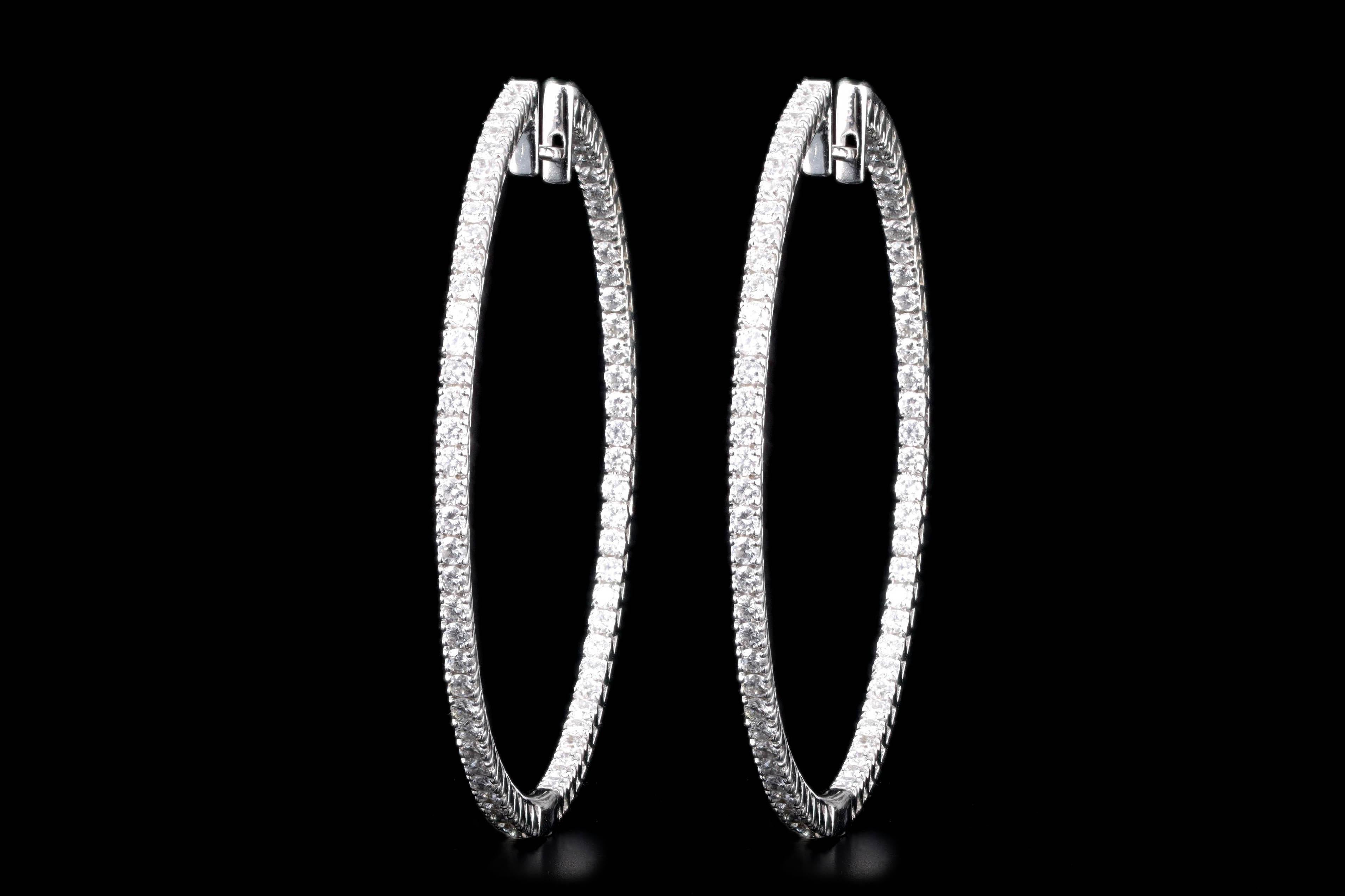 Era: Modern

Composition: 18K White Gold

Primary Stone: One Hundred Forty Two Round Brilliant Cut Cut Diamonds

Total Carat Weight: Approximately 2.2 Carats 

Color/Clarity: G-H / VS1-2

Earring Diameter: 1.8 Inches

Earring Weight: 11.7