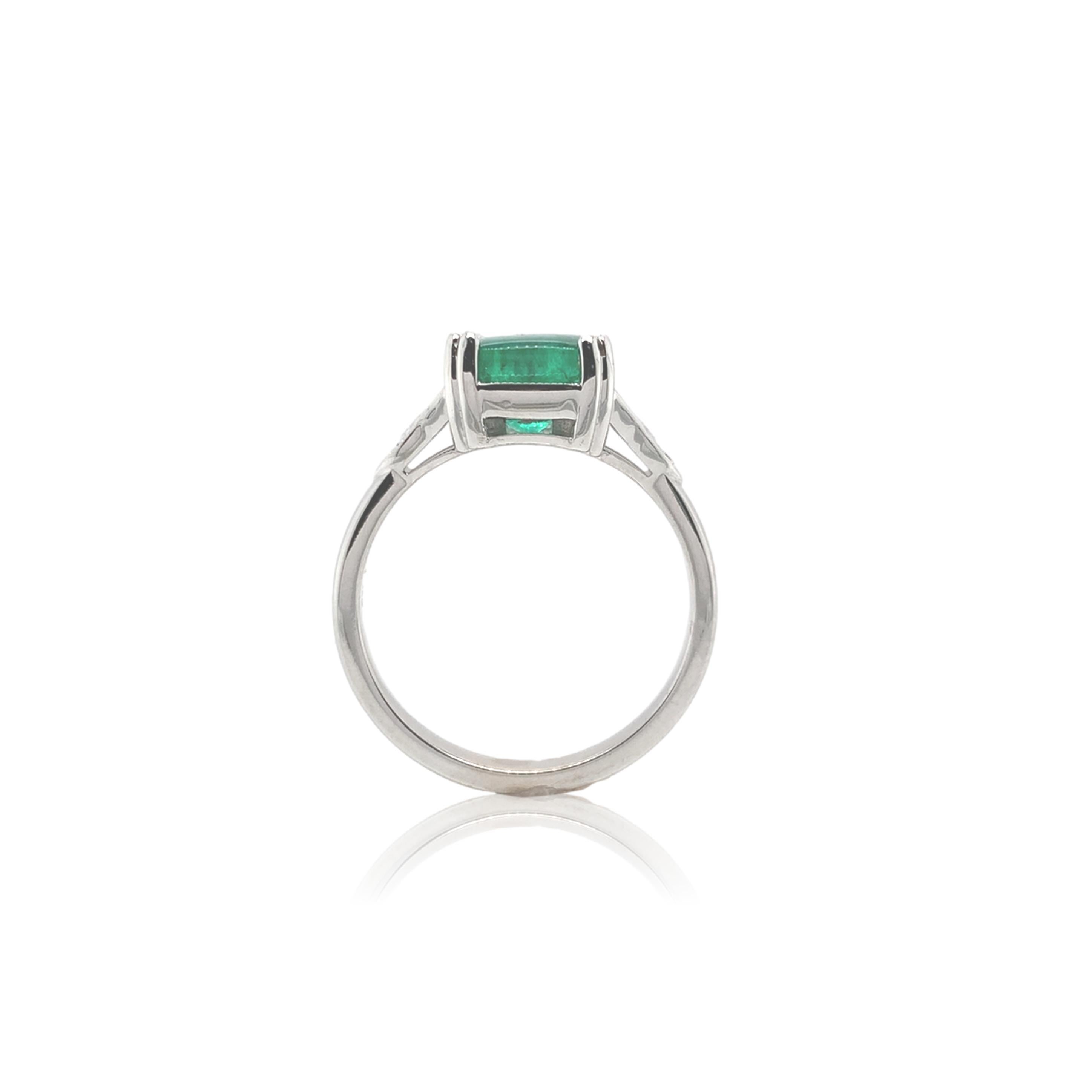 18k white gold ring featuring a genuine earth mined emerald weighing 2.23 carats.  The emerald is a cushion cut cabochon with medium bright green color.  The emerald measures about 7.7mm.  There are 14 small round brilliant cut diamond accents