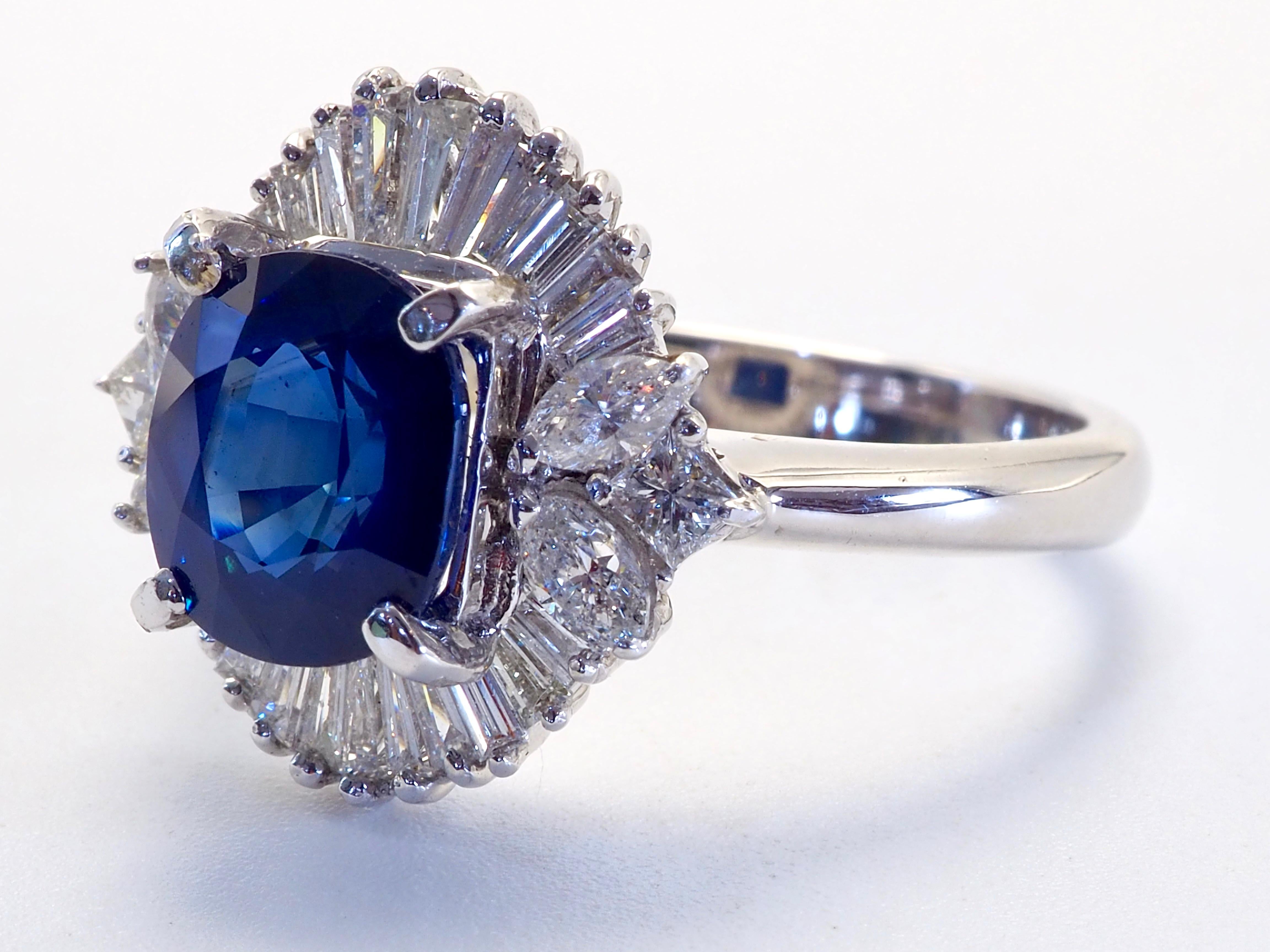 This beautiful cocktail fine ring boasts an astonishingly beautiful oval cut blue sapphire! The sapphire has some natural inclusions with some silk appearing cloudy on some spots- very beautiful. A darker tone sapphire but with decent saturation of