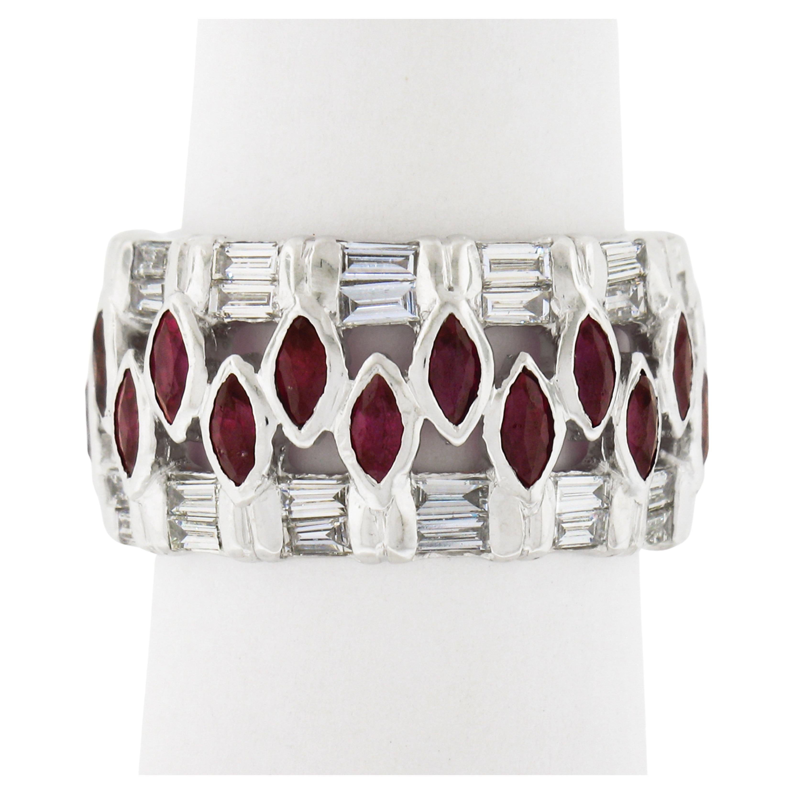 This stunning wide eternity cocktail band ring that is crafted in solid 18k white gold and features a unique design set with a center row of marquise rubies and two side rows of baguette diamonds. The rubies are neatly set in fine bezel settings and