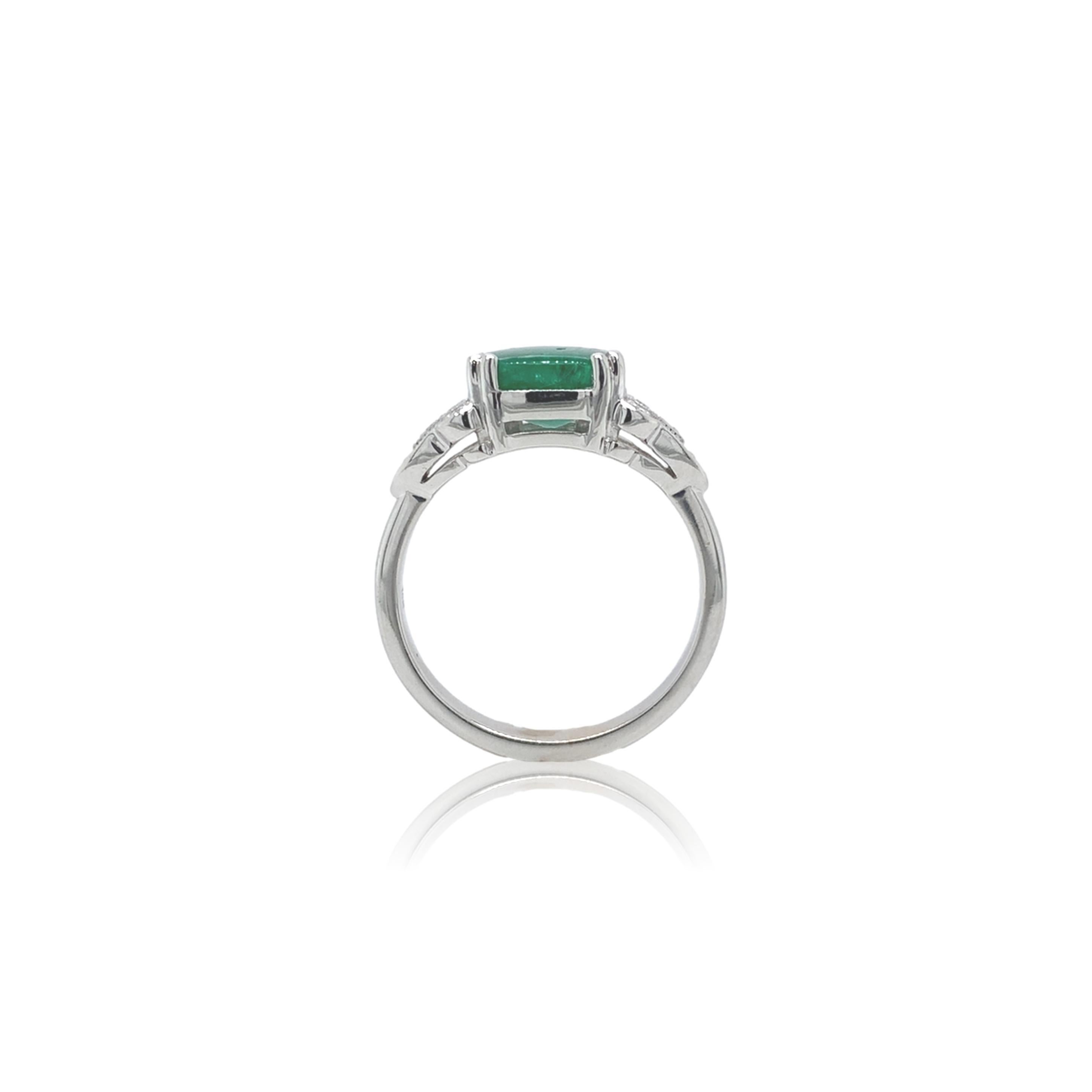 18k white gold ring featuring a genuine earth mined emerald weighing 2.27 carats.  The emerald is a cushion cut cabochon with medium dark green color.  The emerald measures about 8mm.  There are 10 small round brilliant cut diamond accents weighing
