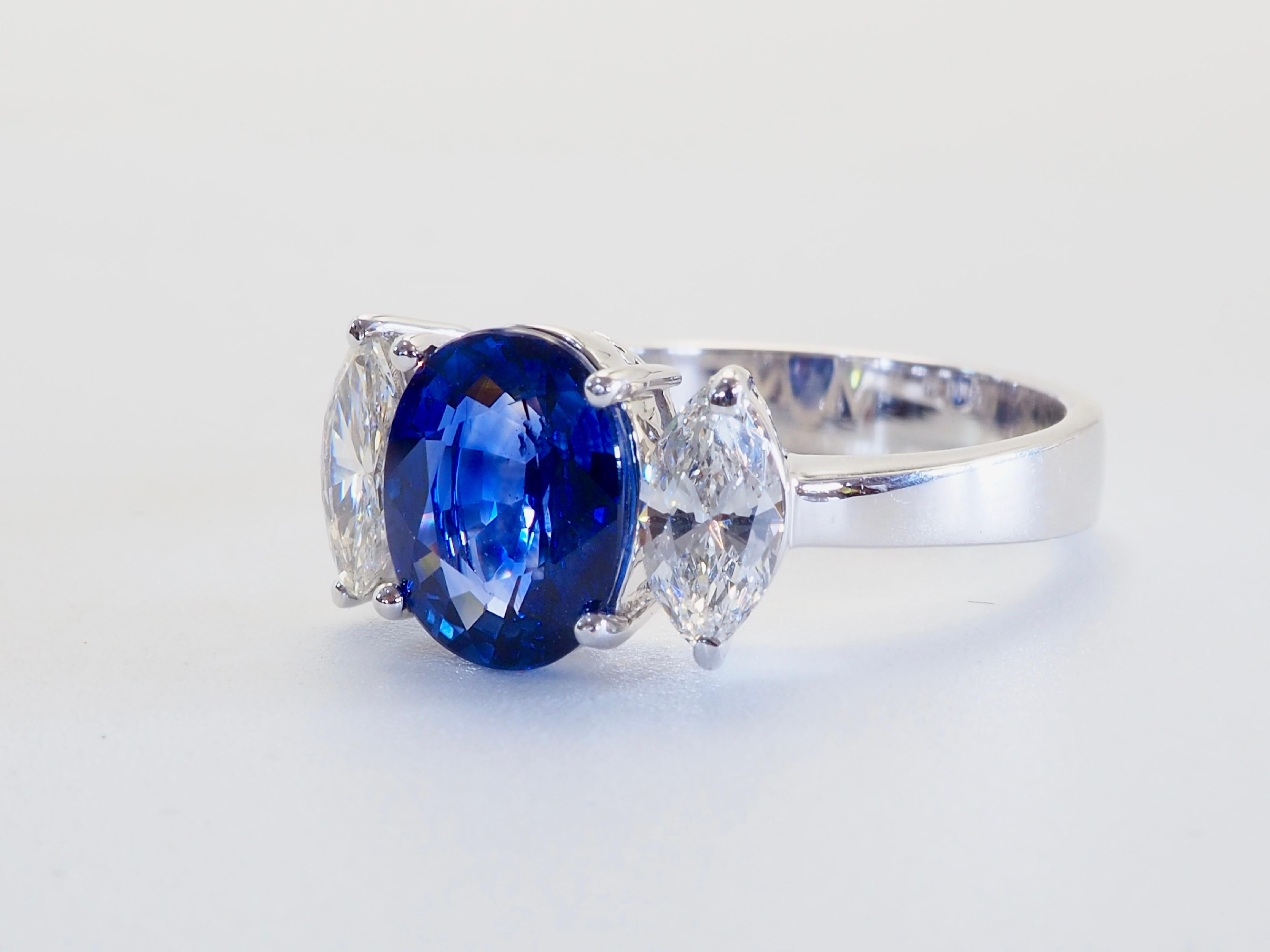 This beautiful and perfect three stone statement thick band fine ring boasts an astonishingly beautiful oval cut blue sapphire! The sapphire has some natural inclusions with some apparent color zoning appearing cloudy on some spots- very beautiful