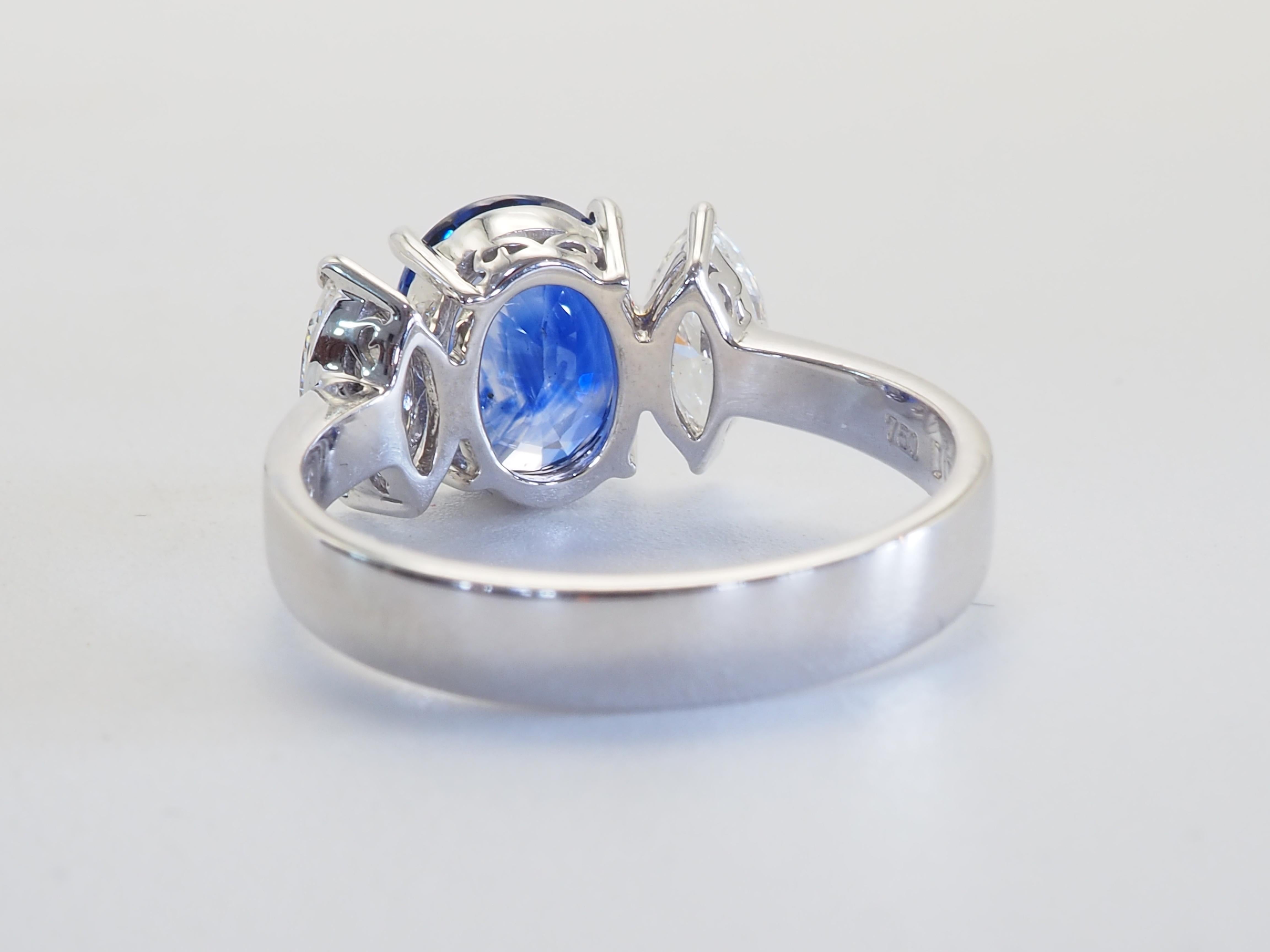 Oval Cut 18K White Gold 2.29ct Vivid Blue Sapphire & 0.57ct Marquise Diamond Ring For Sale