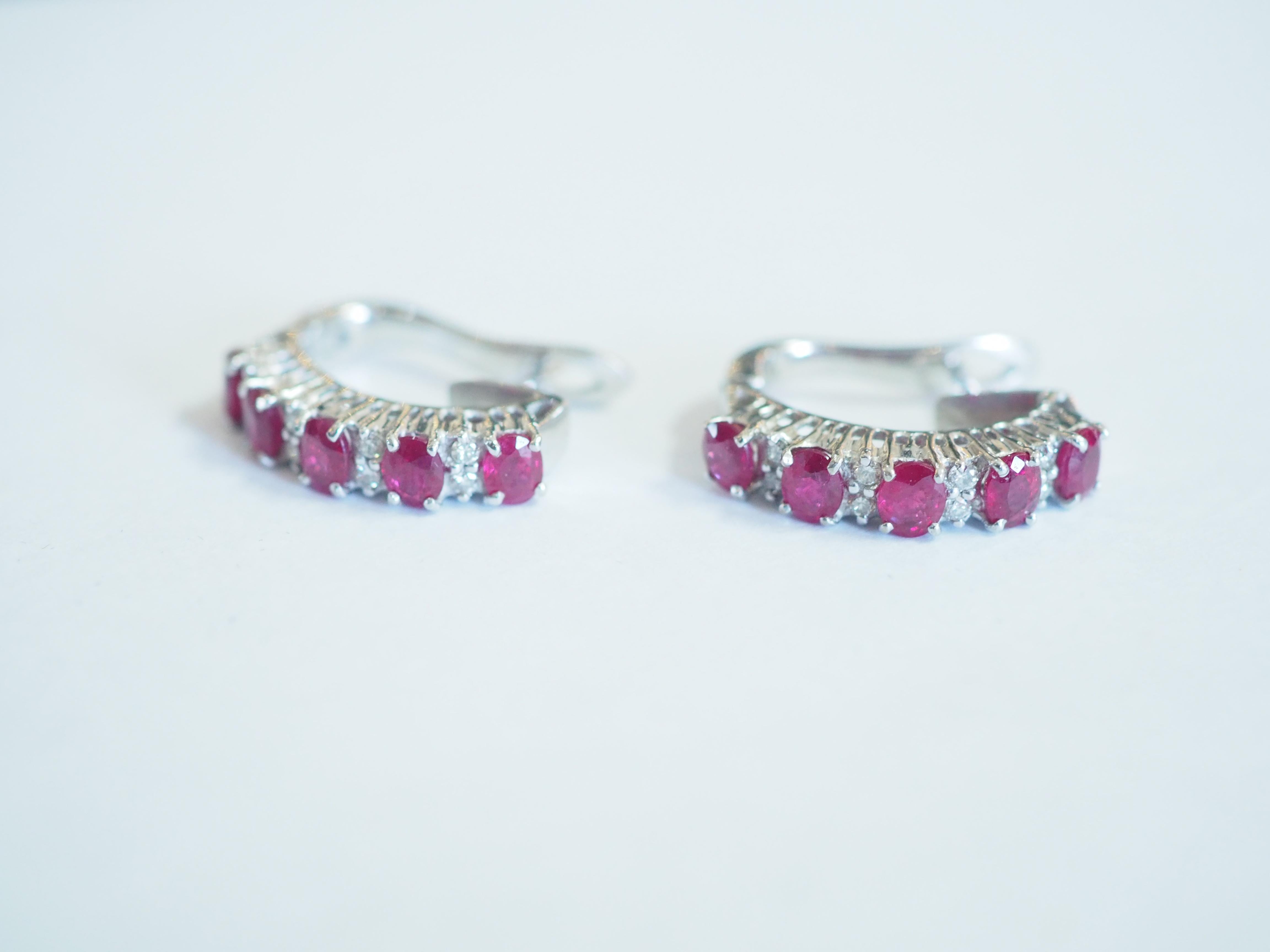 Beautiful latch back earrings made in the 1990's and has never been worn. The earrings have the shape of half circular hoop. There are 10 decent sizes of oval rubies in total and therefore 5 for each ear. The sapphires are all set in prong and with